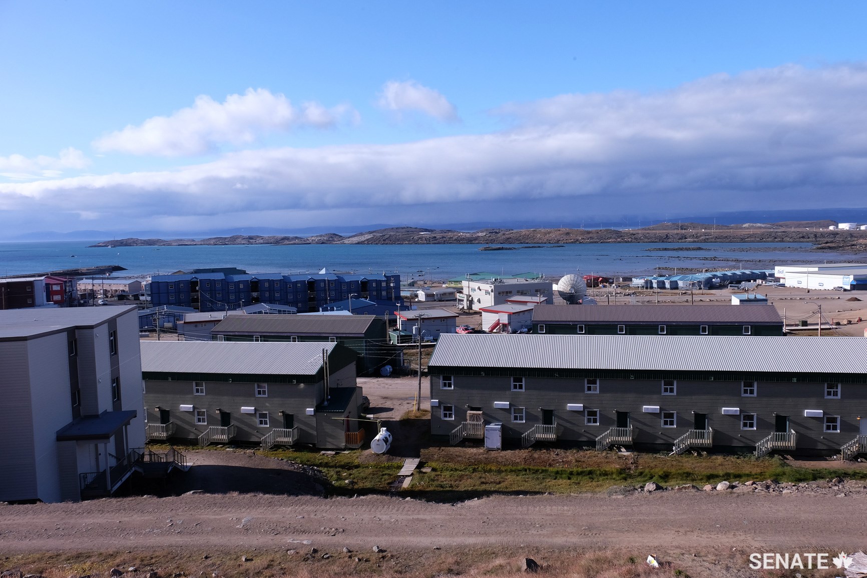 Homes overlook the Koojesse Inlet in Iqaluit, Nunavut. Only 62% of communities in the territory have suitable housing. The cost of building a home and other infrastructure projects in the north can be 150% higher compared to those in the south due to the short shipping and construction season, harsh climate and other factors.
