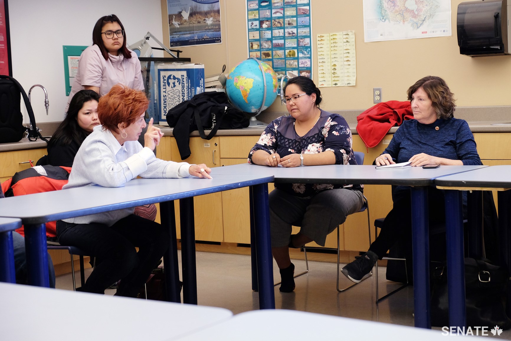 Senators Nicole Eaton and Mary Coyle speak with youth about their educational goals and needs at Aurora College in Inuvik, N.W.T.