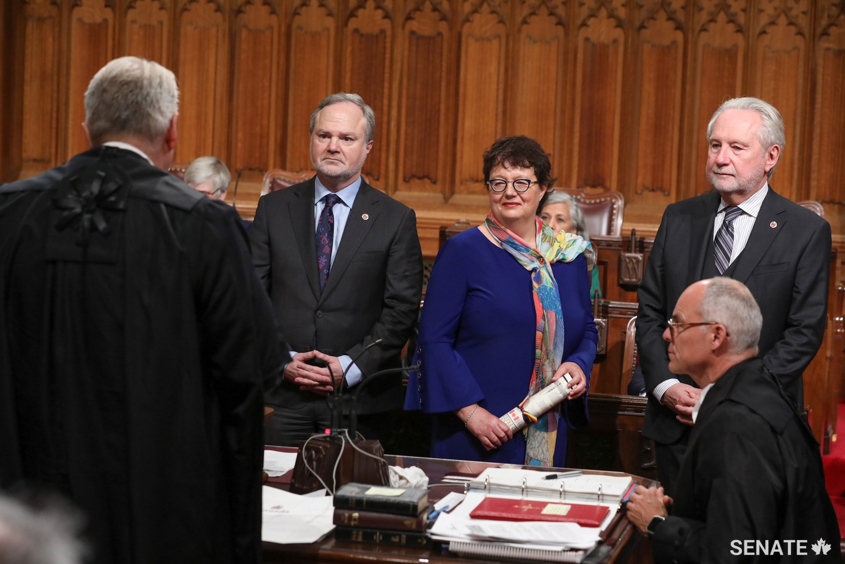 Senator Paula Simons, centre, is joined by Senators André Pratte and Peter Harder during a swearing-in ceremony on October 16, 2018.