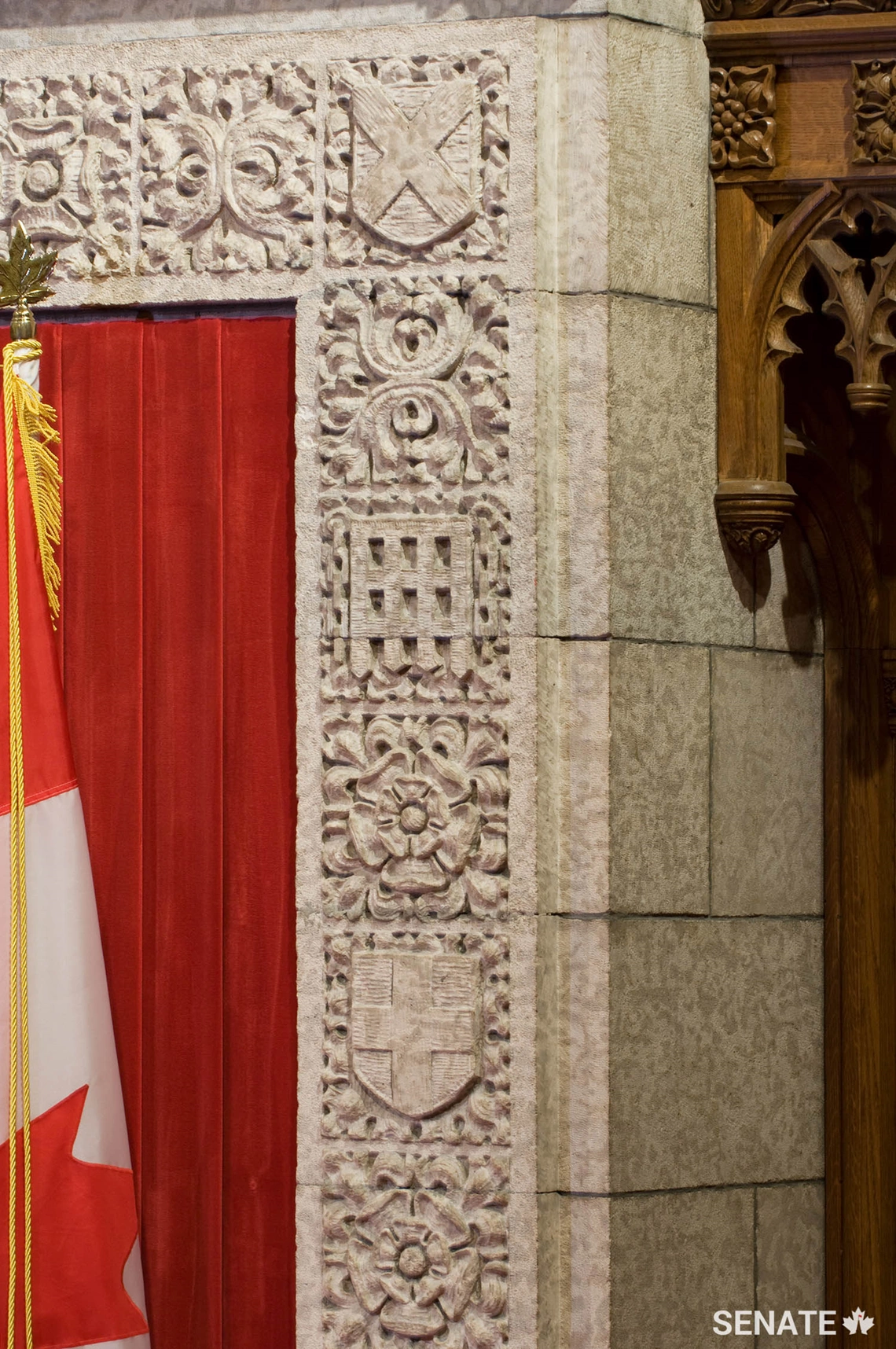The backdrop to the Senate Speaker’s dais is a gallery of British heraldic symbols, including Saint Andrew’s cross, the portcullis emblem of Henry VII, the Tudor rose and Saint George’s cross.
