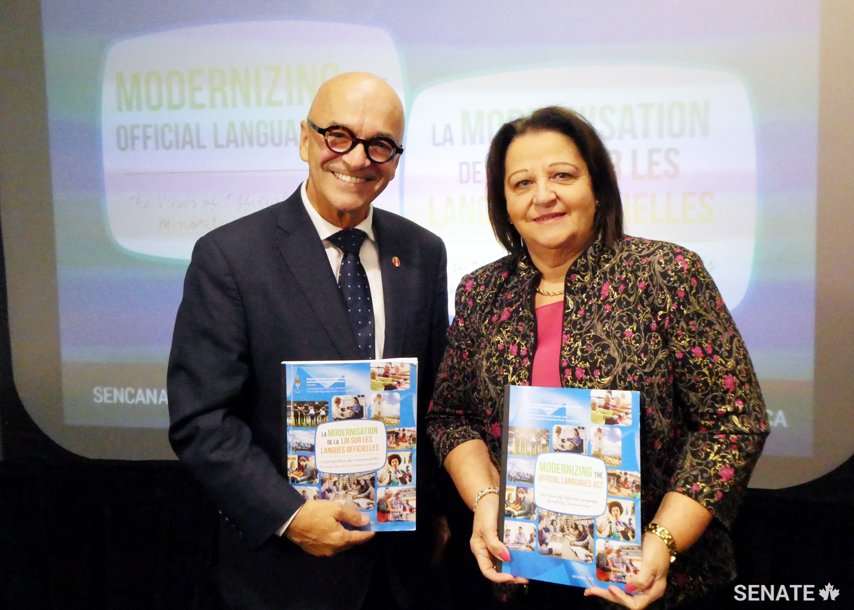On Thursday, October 25, 2018, in Moncton, Senator René Cormier, Chair, and Senator Rose-May Poirier, Deputy Chair, present the Committee on Official Languages report entitled Modernizing the Official Languages Act: The Views of Official Language Minority Communities.