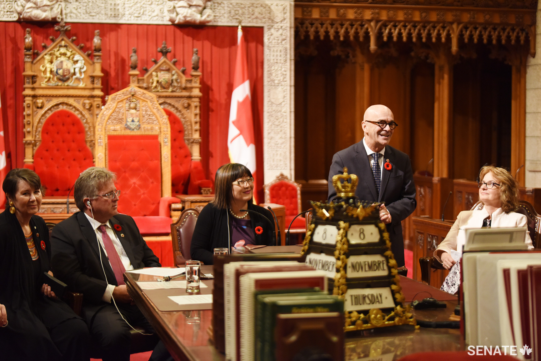 Senator René Cormier addresses teachers in the Senate Chamber during a panel discussion as (from left) Senators Marilou McPhedran, Robert Black, Yonah Martin and Julie Miville-Dechêne listen.
