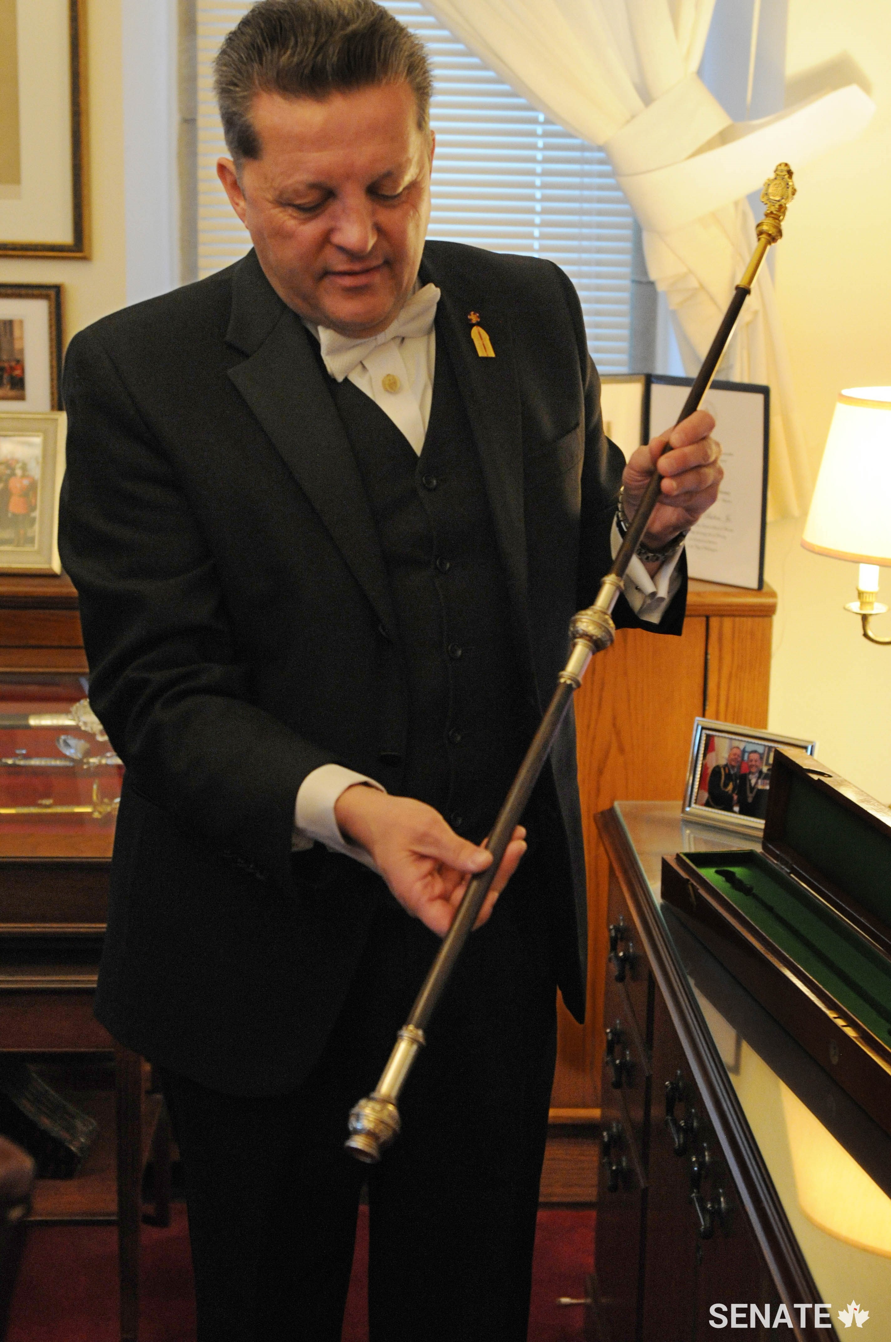 The Usher of the Black Rod, J. Greg Peters, displays the Black Rod currently in use. It was restored in 2016 as a gift, from Her Majesty Queen Elizabeth II, to the Senate of Canada for the sesquicentennial of Confederation. The green velvet-lined case dates to the presentation of the Black Rod to the Prime Minister of Canada, Sir Robert Borden, on June 21, 1918.