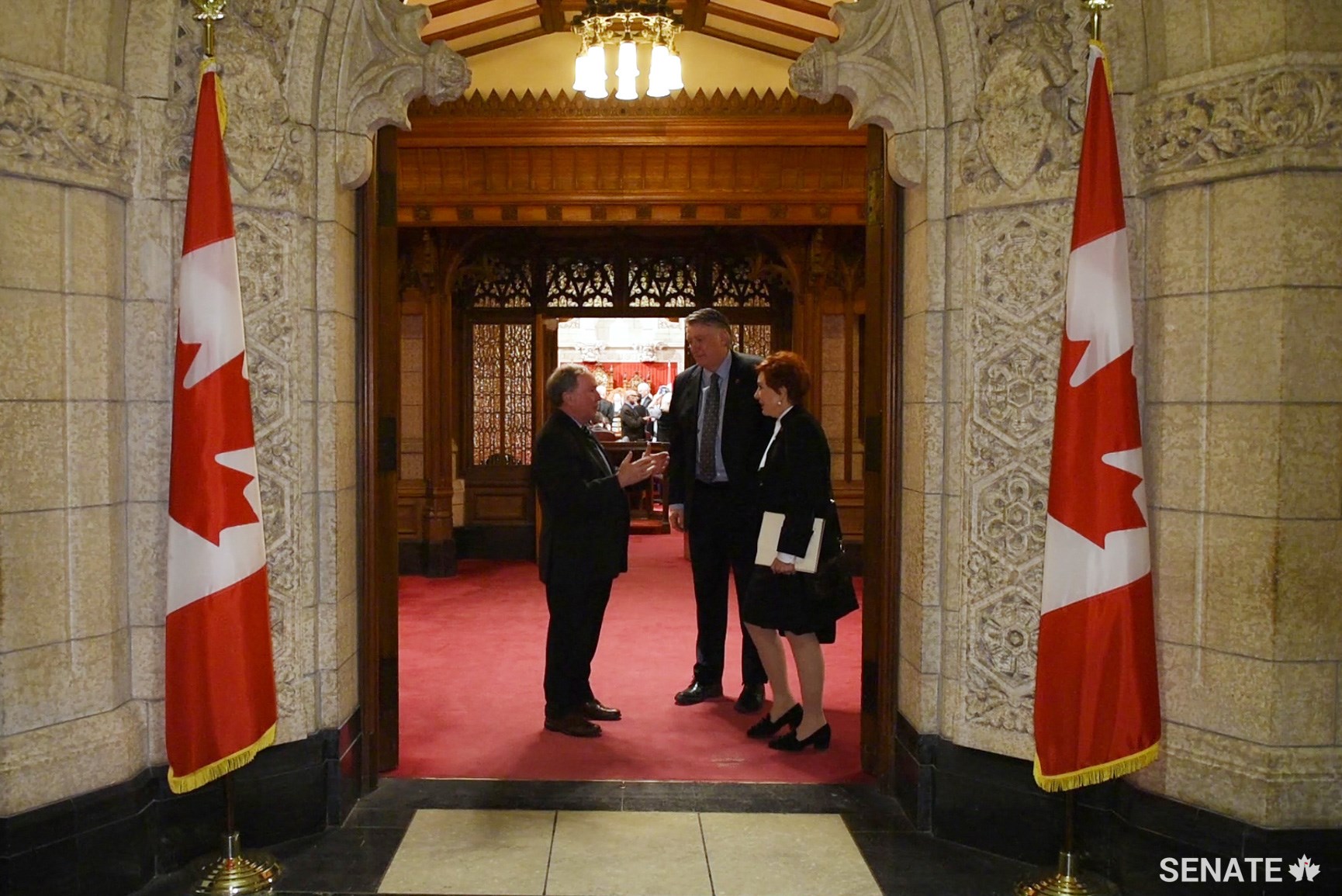 Senators Jim Munson, Scott Tannas and Nicole Eaton chat in the antechamber as they file out of Centre Block’s Senate Chamber for the last time before major restoration work begins in the building.