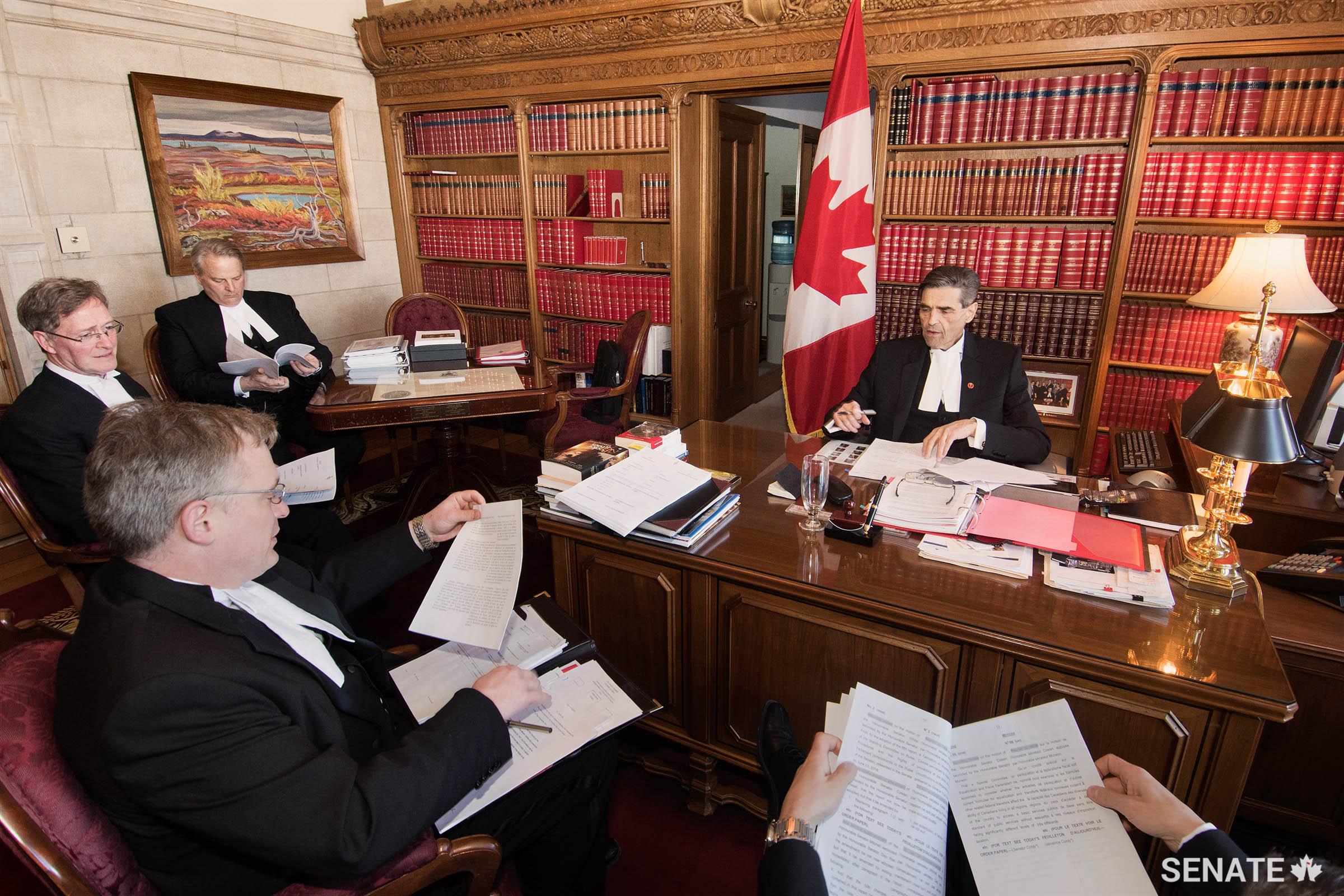Keeping the Senate running smoothly: Senator Pierre Claude Nolin, Speaker of the Senate from November 2014 to April 2015, meets with senior procedural officers to review the agenda for an upcoming Senate sitting.