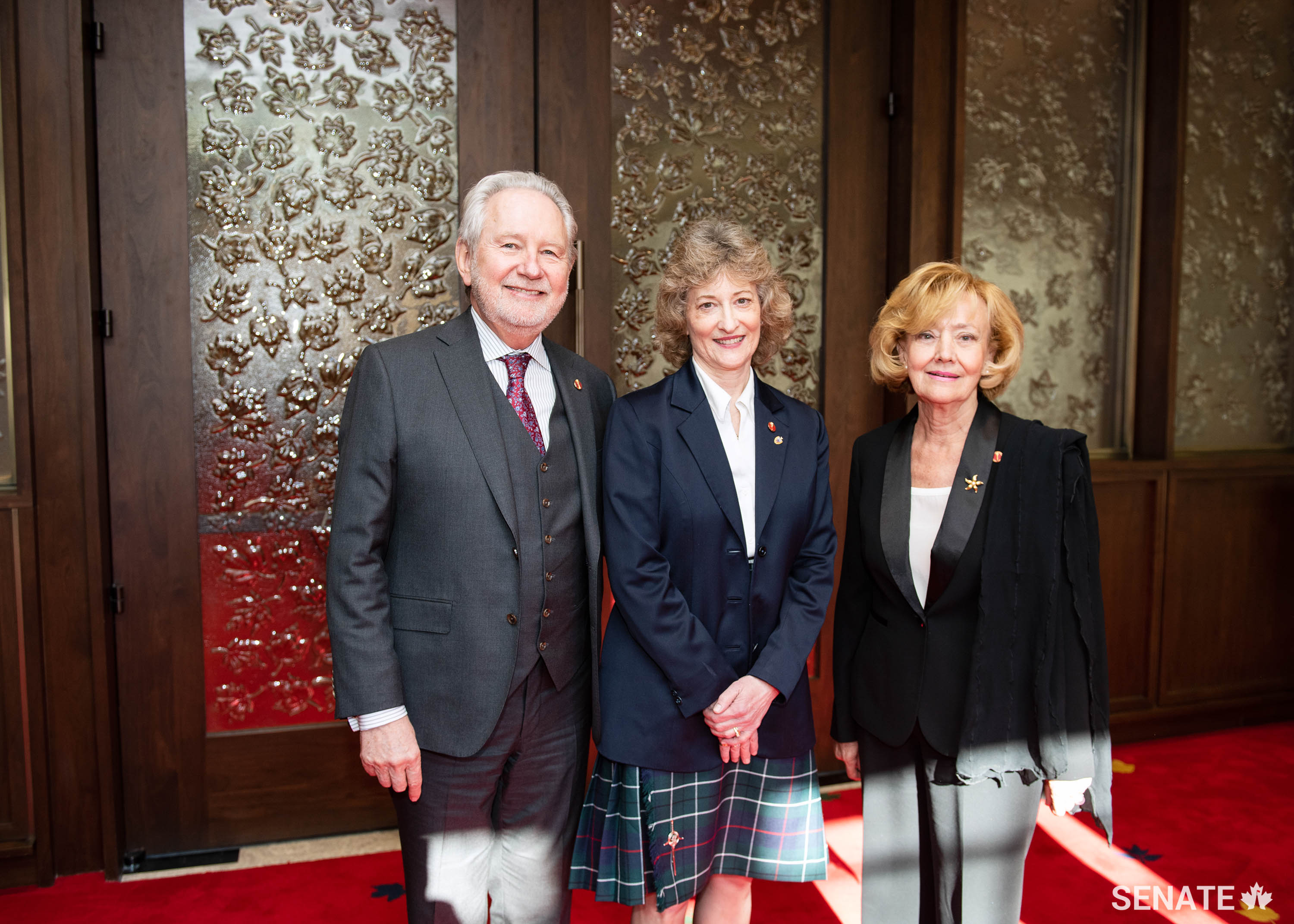Senators Peter Harder and A. Raynell Andreychuk welcome Senator Pat Duncan, centre, to the Senate of Canada on February 19, 2019.