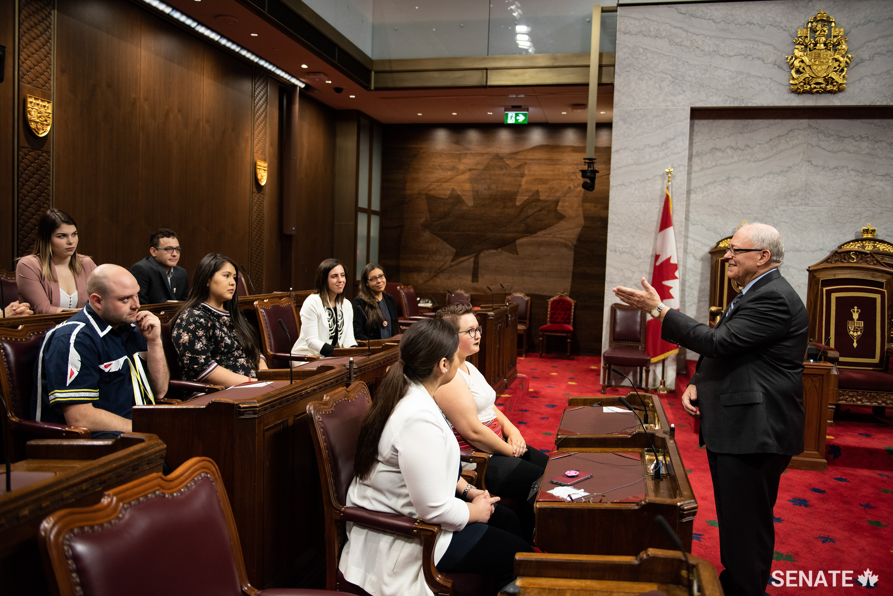 Senate Speaker George J. Furey speaks to Indigenous youth during a tour of the Red Chamber on June 5, 2019.