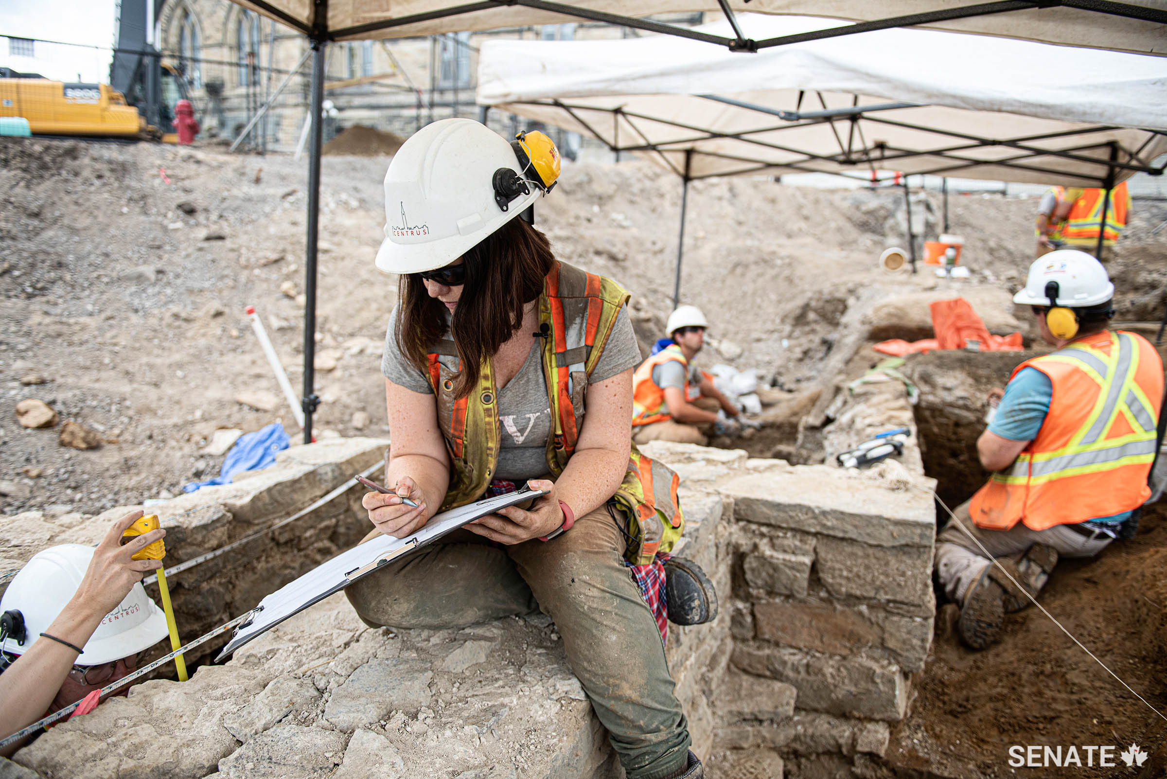 Archaeologist Becky Remmer works on a scale drawing of the guardhouse’s foundation wall.