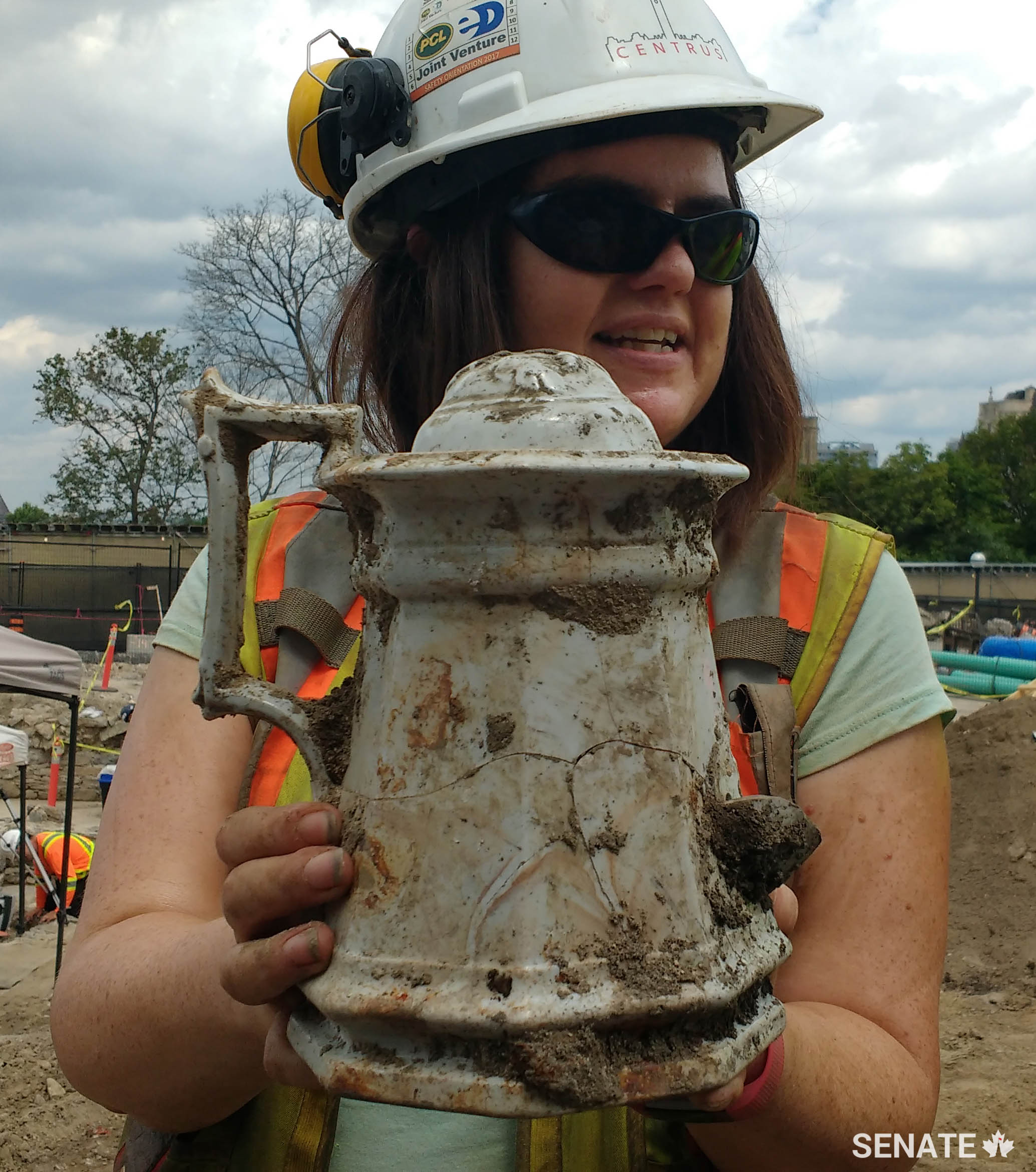 Archaeologist Becky Remmer holds a tea pot that was discovered on the site.