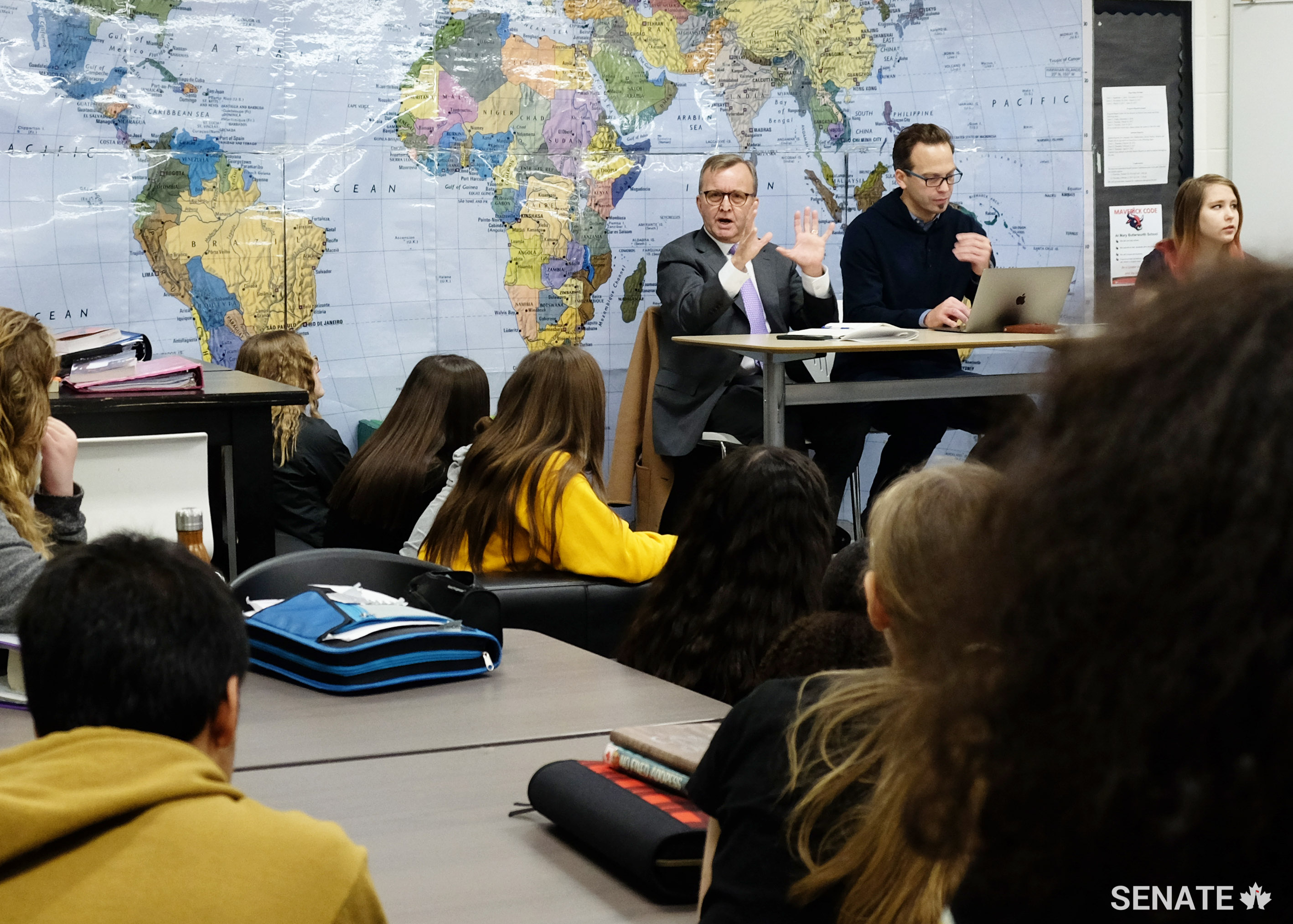 Senator Grant Mitchell answers a question from students at Mary Butterworth School in Edmonton as Centre for Global Education Executive Director Terry Godwaldt monitors the videoconference.