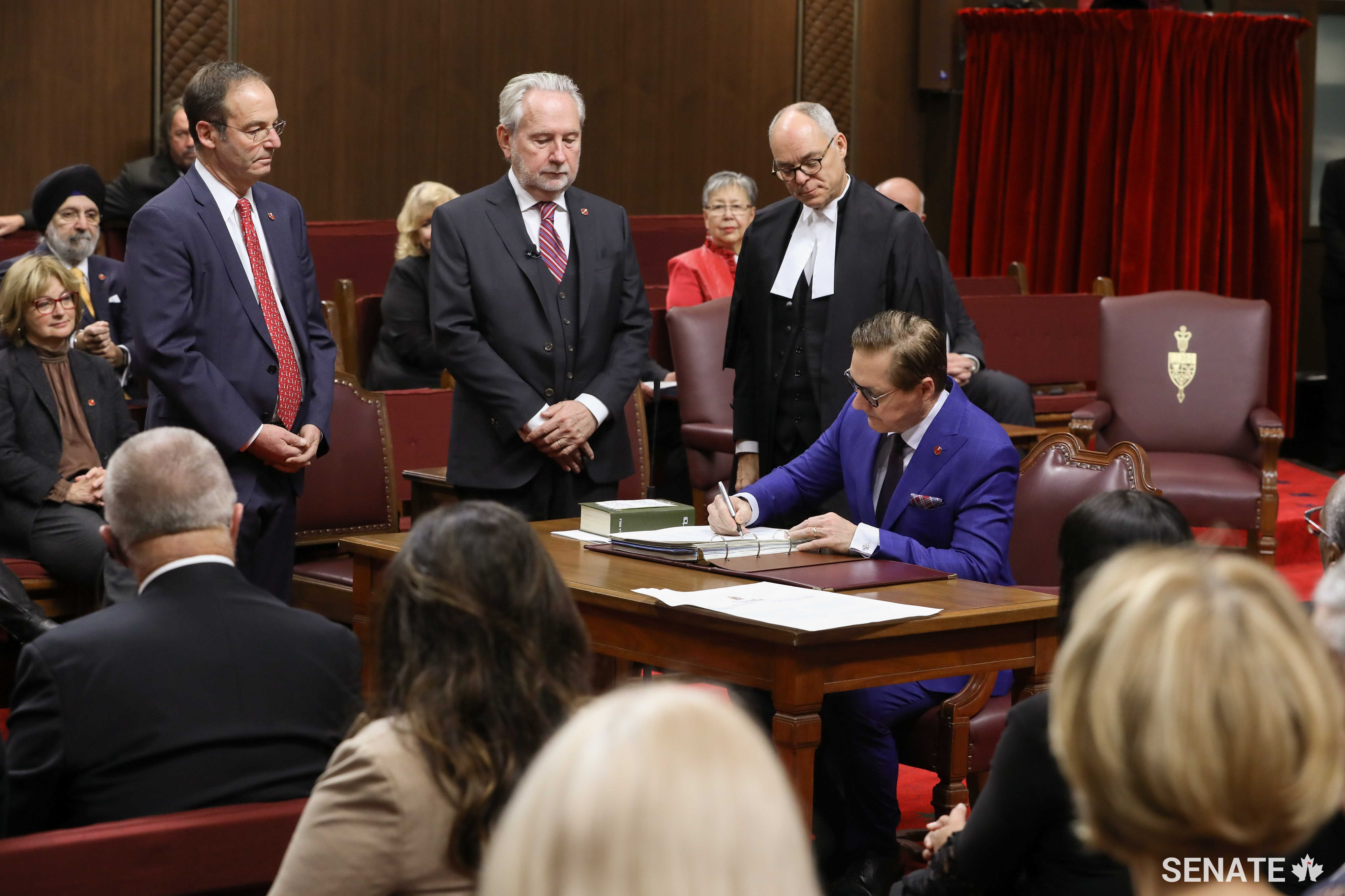 Senator Tony Loffreda is sworn in as a senator on December 5, 2019, as Senator Marc Gold, Senator Peter Harder and Interim Clerk of the Senate Richard Denis look on. 