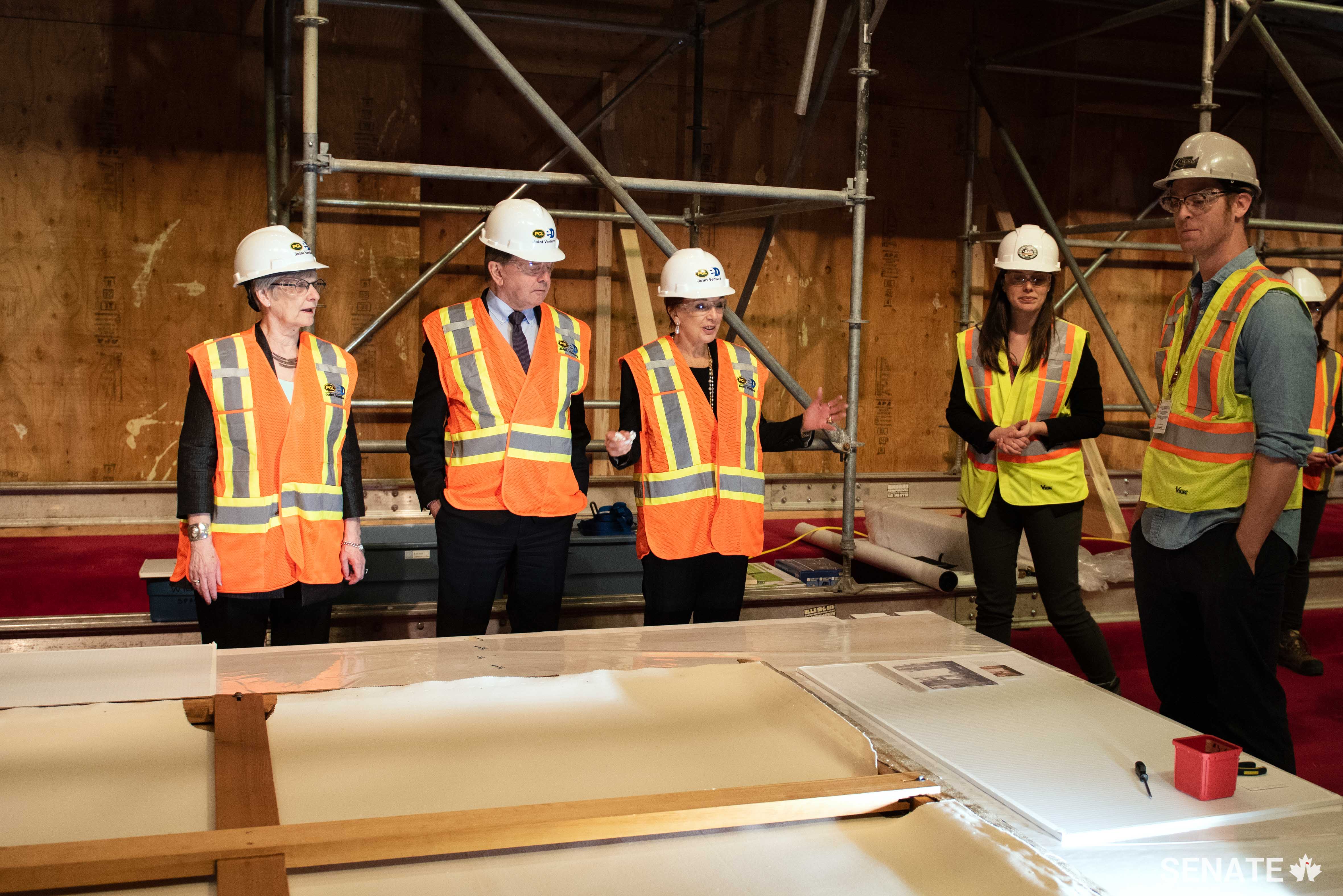 Senator Eaton, third from left, observes a war painting that had been hanging in the Senate’s permanent home in Parliament’s Centre Block building. Senator Eaton was a member of the Senate’s Artwork Advisory Working Group, which oversaw the move of dozens of historic war paintings from Parliament Hill while Centre Block is undergoing a major rehabilitation. 