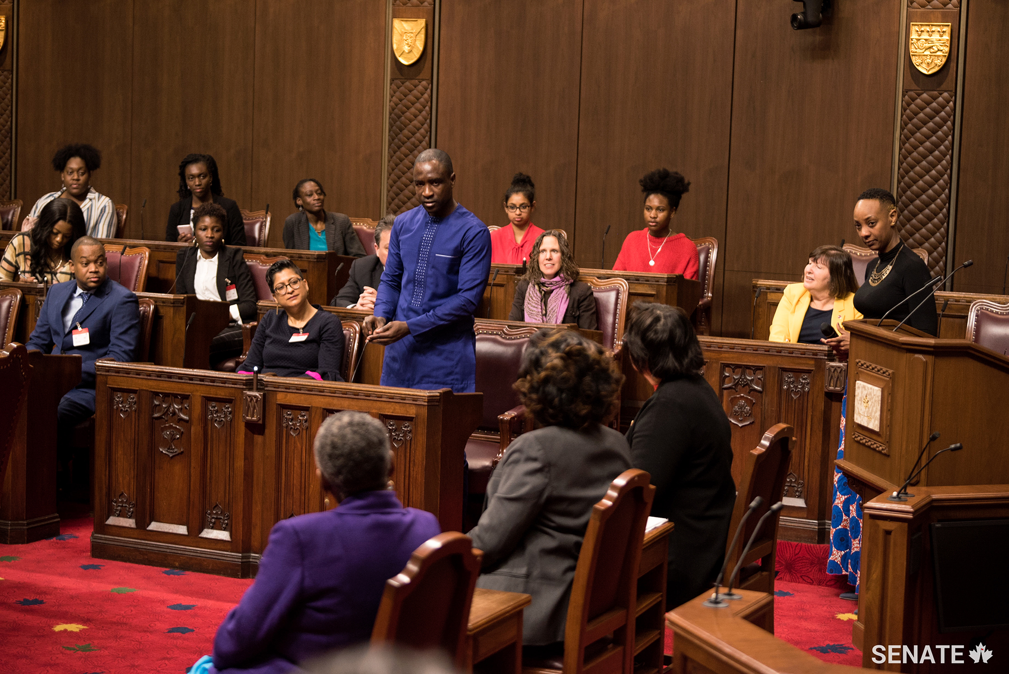 A student asks a question during the Black History Month event in the Senate Chamber.