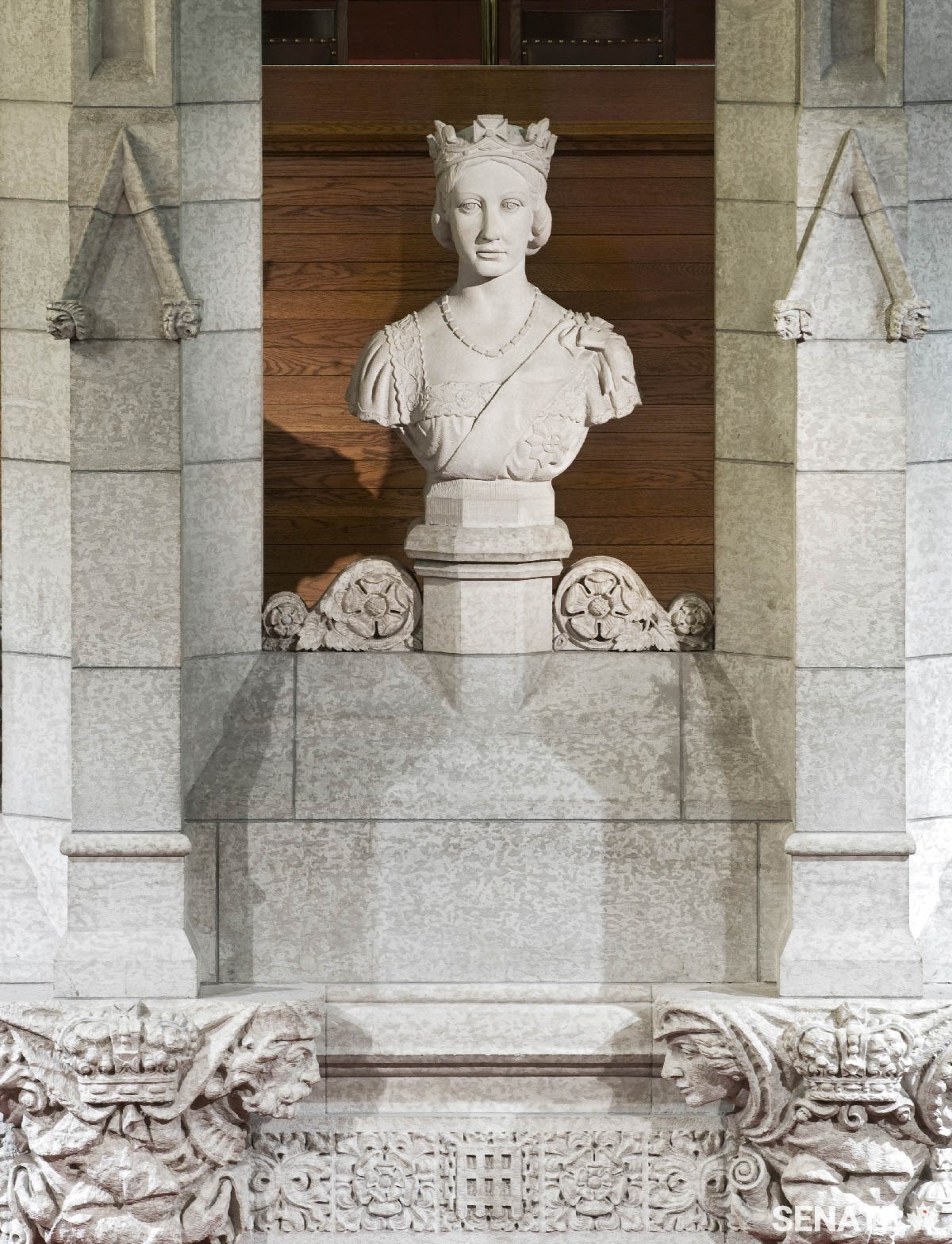 In the Senate Chamber, Cleóphas Soucy and his team created the backdrop to the Speaker’s dais. It’s decorated with stylized heads of medieval courtiers and topped with a marble bust of Queen Victoria.