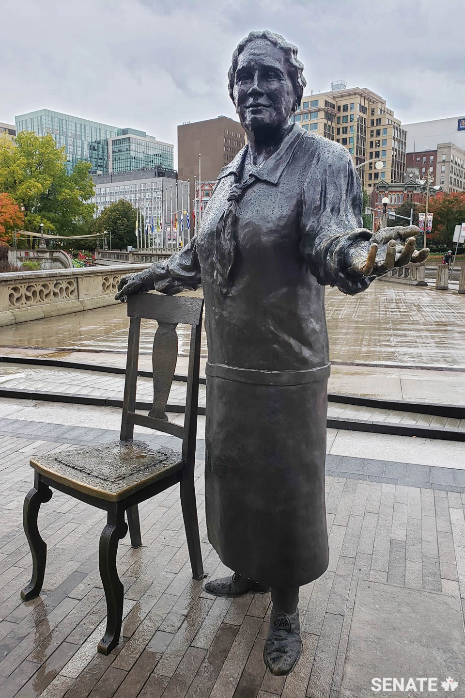 Details, such as this empty chair beside Emily Murphy, invite visitors to interact with the sculpture. “I love to see that shiny patina on the seat and chair back,” Mrs. Paterson said. “Nothing pleases me more than to see signs that the sculpture has been touched and handled.”