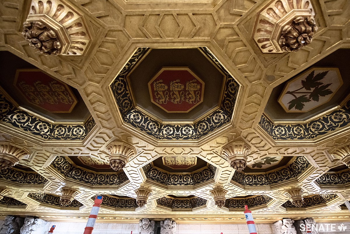 The gold on the Senate ceiling is real — in a painstaking process, workers brushed small rectangles of thin gold leaf onto almost every surface of the intricately sculpted plaster ceiling. The dark patterns on the inside rim of the coffers were added using stencils and paint.