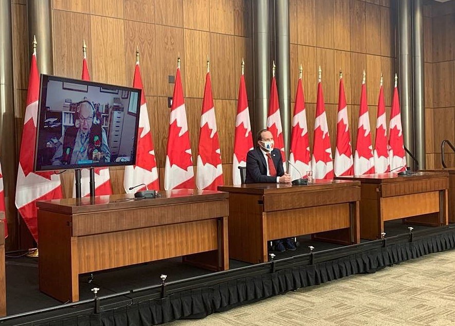 Senator Sinclair appears on a television screen to announce the introduction of the Jane Goodall Act alongside MP Nathaniel Erskine-Smith at a press conference on November 17, 2020.