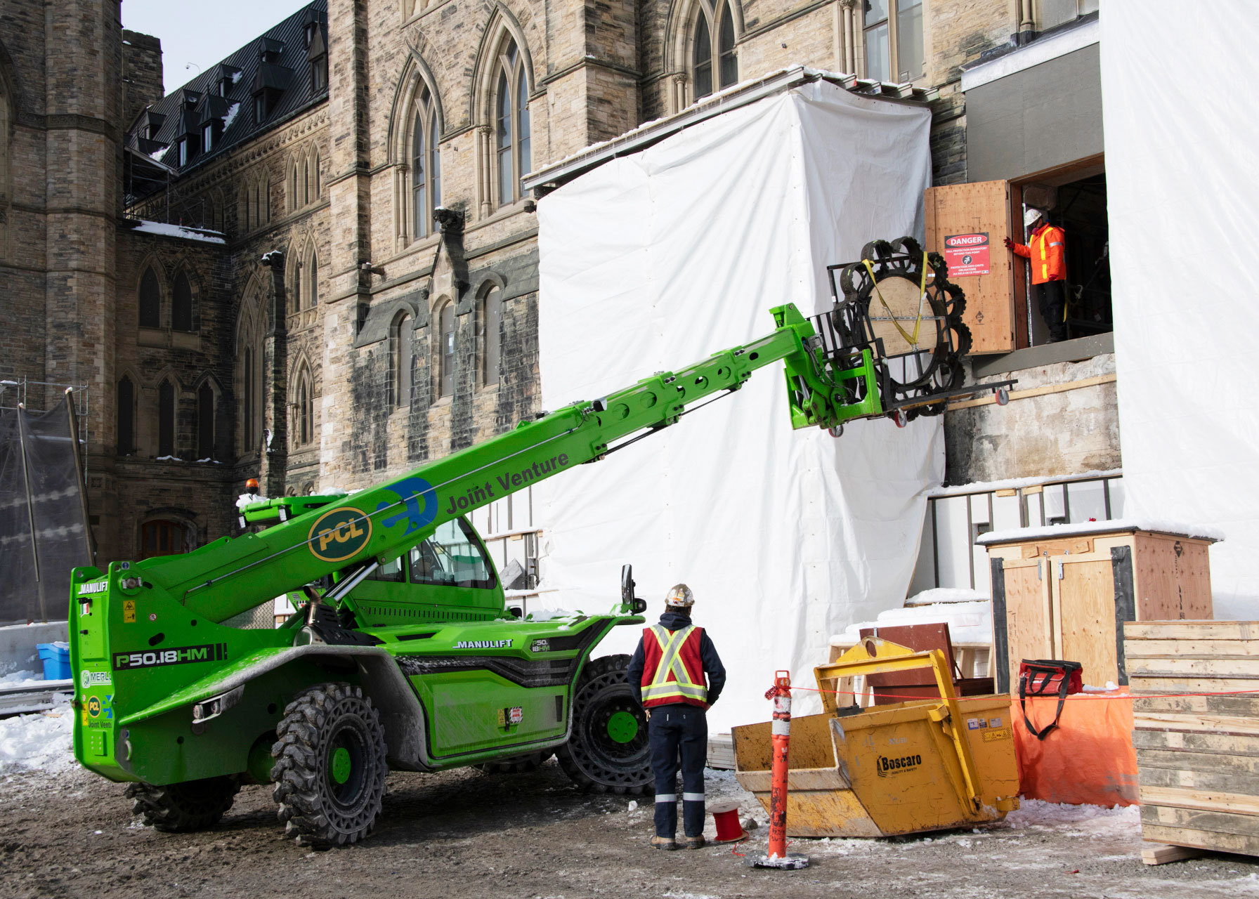 One of the heavy chandelier rings finally exits the building through the Senate entrance on Centre Block’s east side. The entrance is typically at ground level but appears elevated due to excavation work. (Photo credit: Public Services and Procurement Canada)