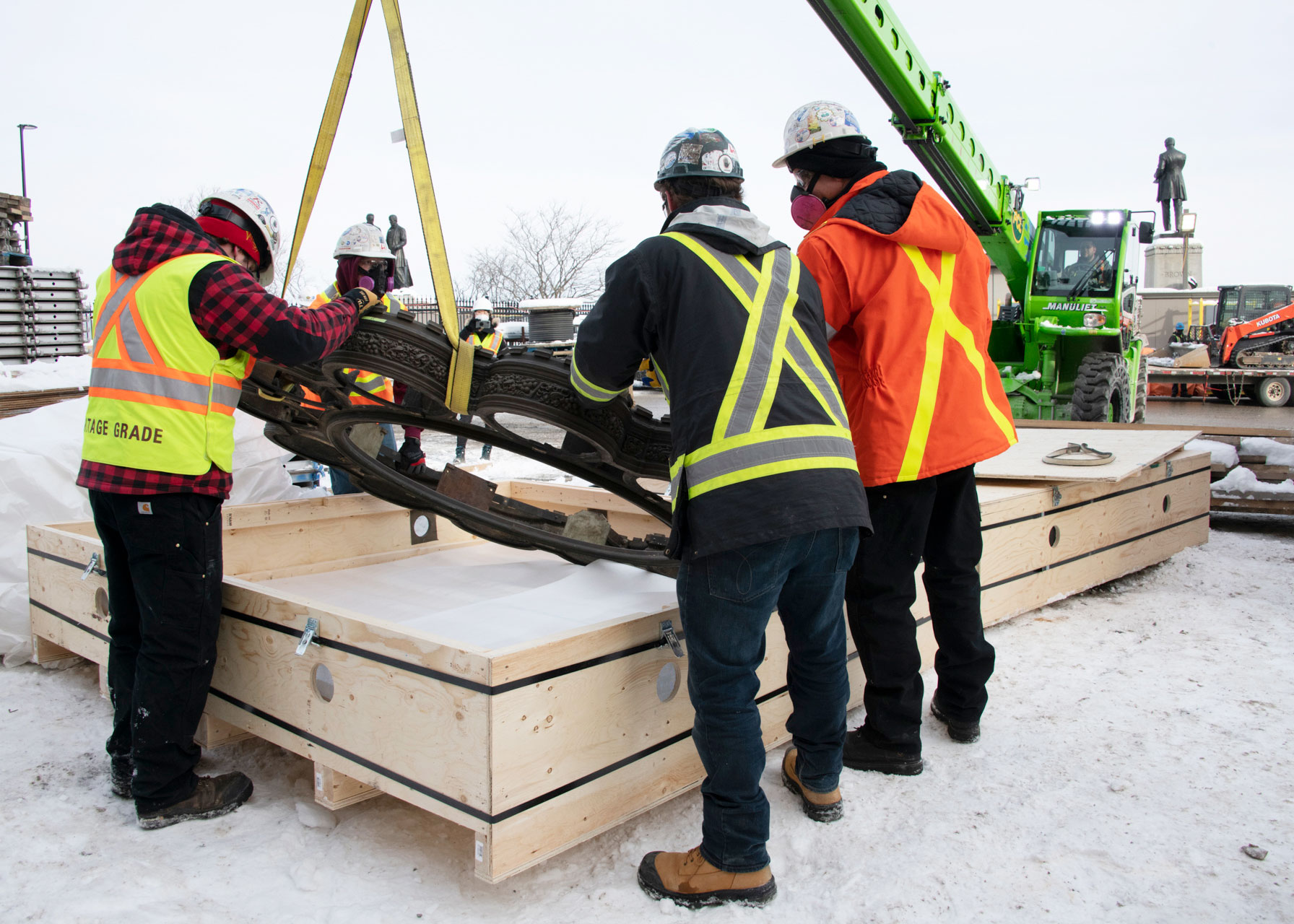 Workers crate one of the chandelier rings for storage. Different components of the Senate chandeliers are being stored in a federal warehouse while restoration plans are finalized. (Photo credit: Public Services and Procurement Canada)