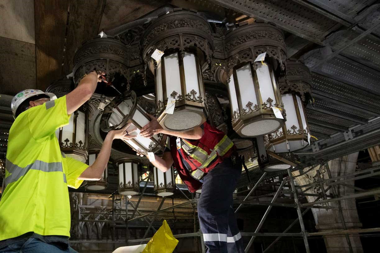 Centre Block’s major rehabilitation means the two chandeliers can’t hang around. To reduce the load when lowering the fixtures to the ground, workers unfasten as many heavy pieces as possible and remove the fragile lanterns. (Photo credit: Public Services and Procurement Canada)