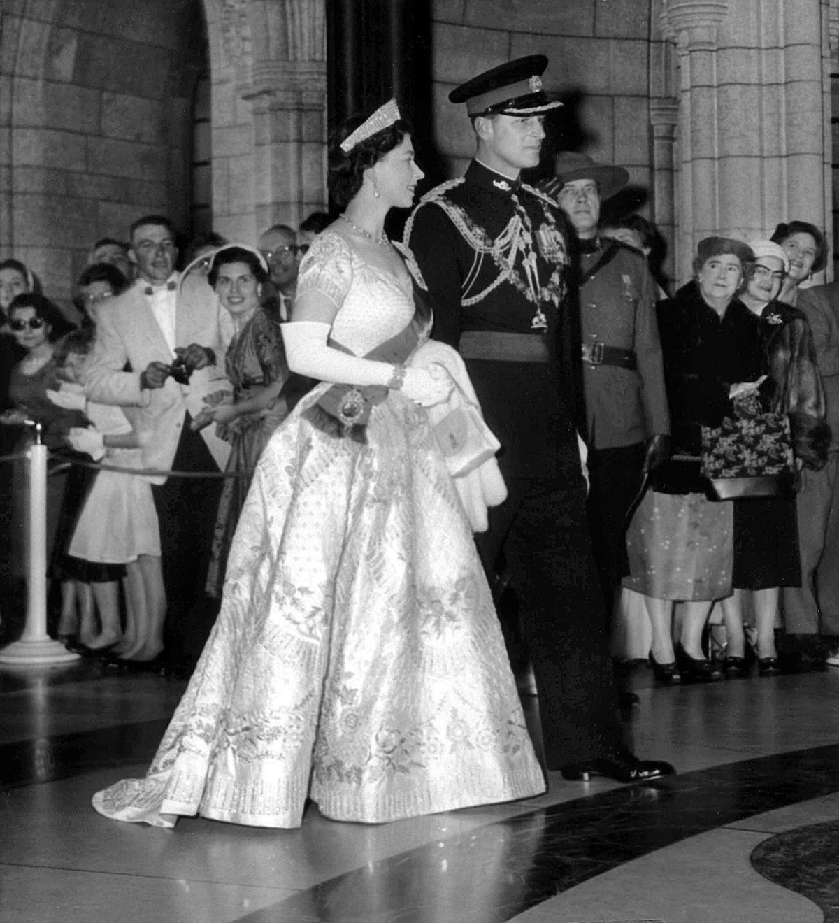 Queen Elizabeth and Prince Philip enter Centre Block for the opening of Parliament in 1957. The Queen wears her 1953 coronation gown and Prince Philip wears the uniform of a colonel-in-chief of the Royal Canadian Regiment. (Photo credit: The Canadian Press)
