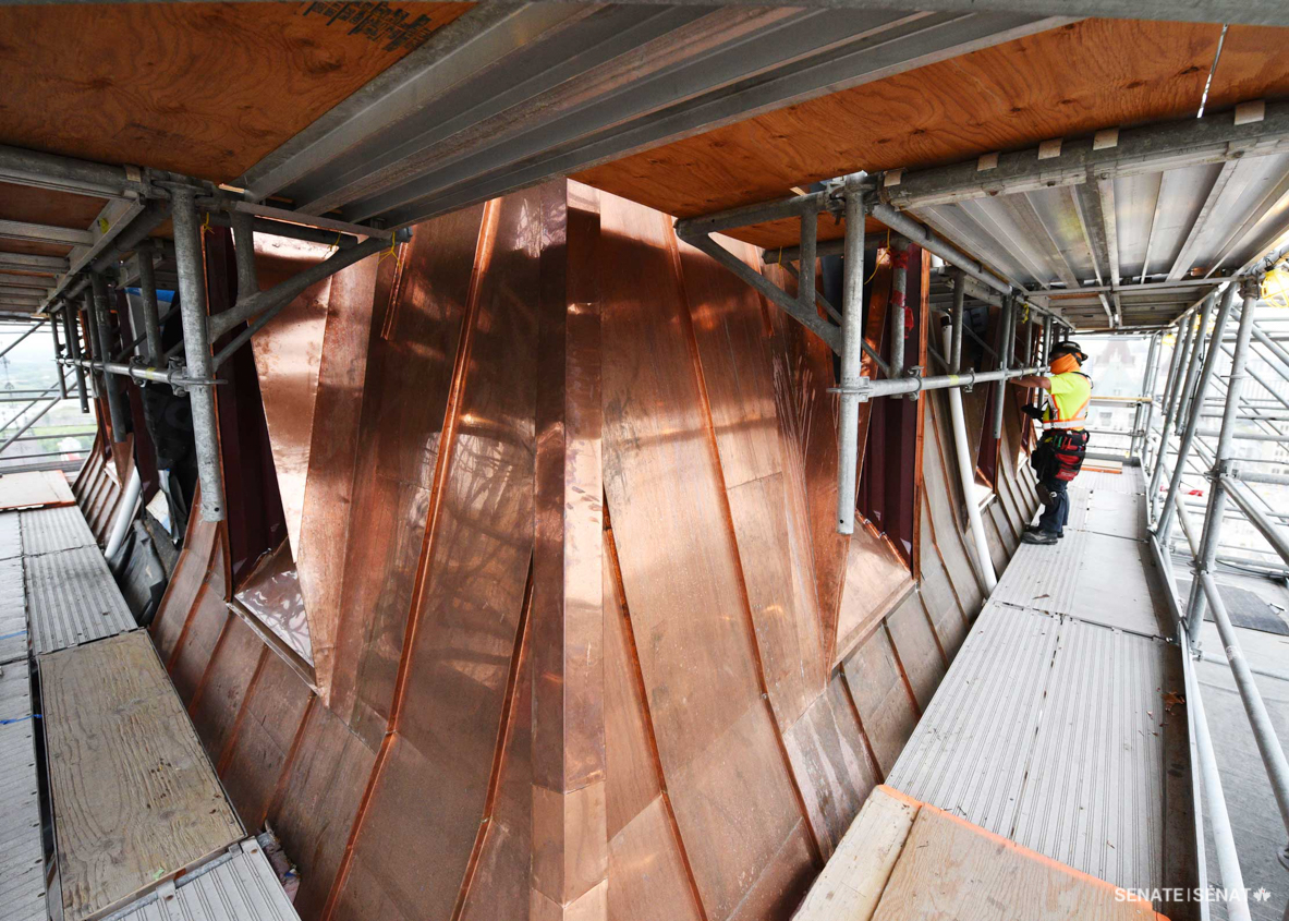 East Block’s roofs were originally made of slate, but the brittle material was replaced with copper roofing in the mid-1900s. As part of the building’s rehabilitation today, the southwest and southeast towers are getting new copper roofs. Untreated copper roofing will quickly turn brown and eventually take on a greenish hue as it oxidizes.