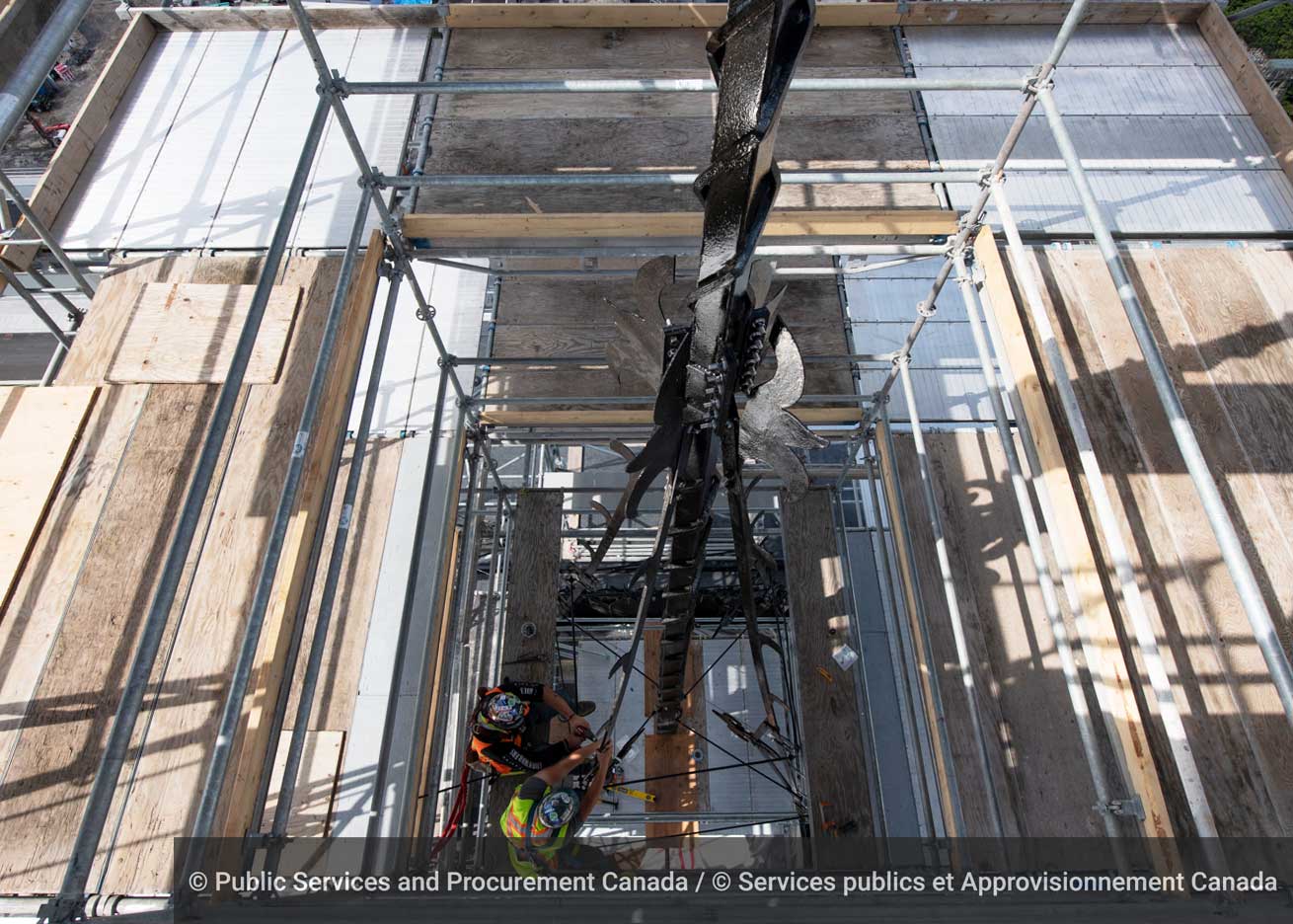 Piece by piece, workers re-install the iron spire — believed to be original to East Block — after rehabilitation work and a fresh coat of paint. Four iron arms support the 12-metre-tall spire, similar to ropes that stabilize a ship’s mast. (Photo credit: Public Services and Procurement Canada)