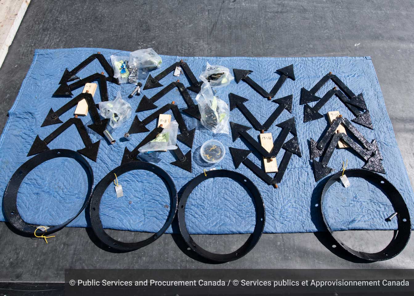 Refurbished parts of the wrought-iron spire that tops East Block’s southwest tower rest on a sheet. Wrought iron is created by fusing layers of iron together. While it’s malleable, it does wear down and become vulnerable to snapping after being exposed to the elements for a long time. (Photo credit: Public Services and Procurement Canada)