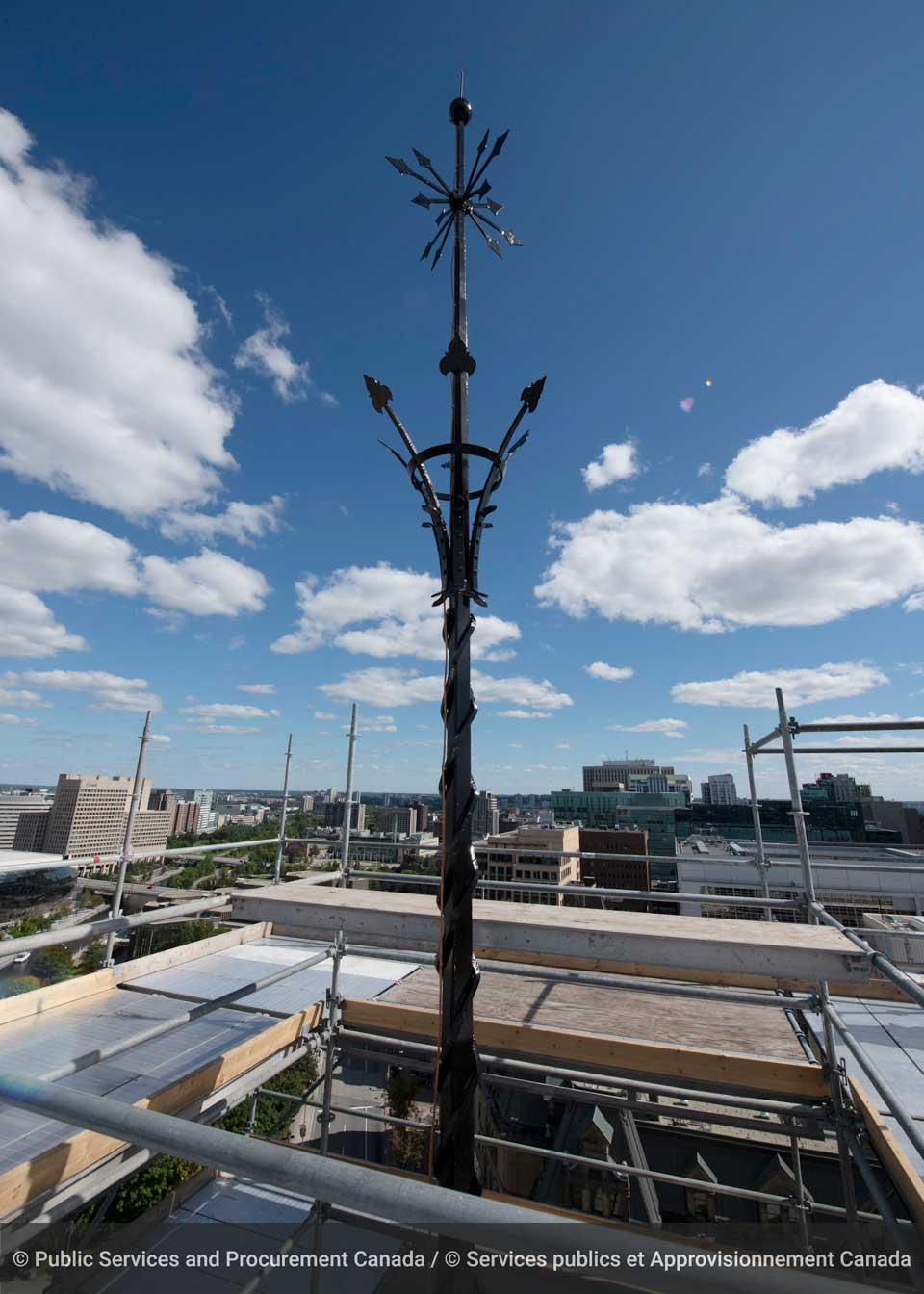 The tip of East Block’s reinstalled iron spire pokes out of a cocoon of scaffolding. If you look closely, you can see a lightning protection spike at the top. If a lightning bolt were to strike the top of the spire, the energy would flow down the wiring that runs down the spire and tower to prevent heat damage. (Photo credit: Public Services and Procurement Canada)