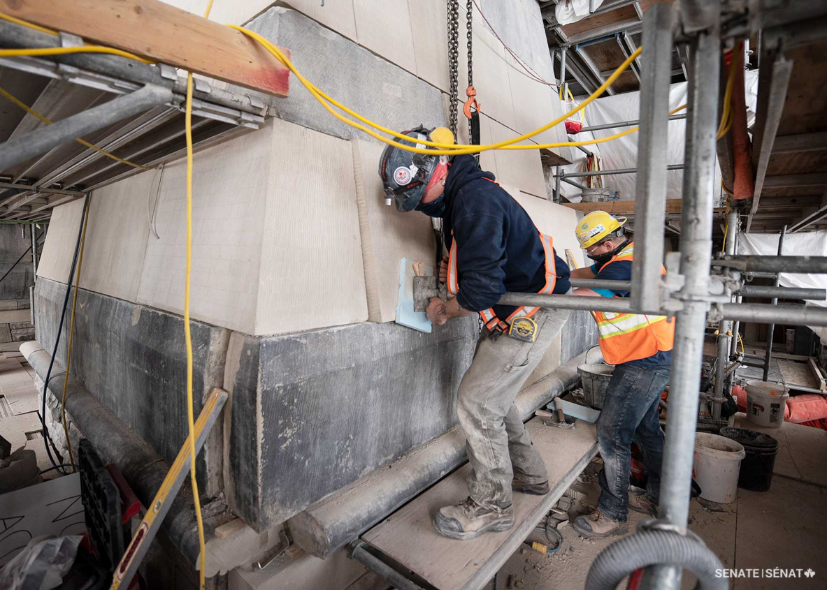 Workers push in a newly cut Berea sandstone block into the wide base of East Block’s southwest tower — the building’s tallest tower. Replacing and repairing these massive blocks is akin to playing Jenga; only so many of the stones can be removed at one time so the tower’s structural integrity isn’t compromised. Workers followed all construction safety and public health rules in place at the time the work was performed.