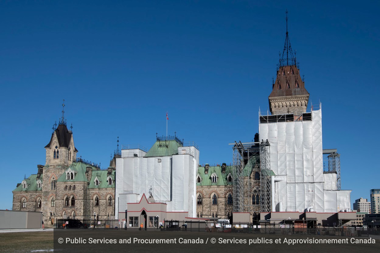 East Block is pictured surrounded by scaffolding and construction activity, following the replacement of the copper roofing on the southwest tower — the tallest tower. (Photo credit: Public Services and Procurement Canada)