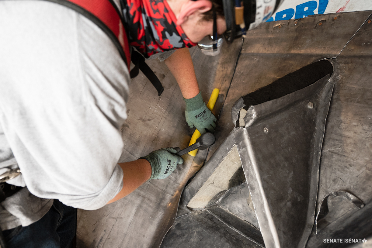 A worker installs protective lead sheets over East Block’s exterior masonry elements — a process known as “capping” — to help prevent damage to the stonework. Since lead is a naturally flexible material, the sheets can closely envelop the masonry’s details and help absorb the shock from falling ice and snow.