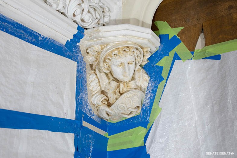 Step 1: The project begins with surface preparation. A century’s worth of paint, sometimes several layers thick, is carefully removed to reveal the sculptures in all their detail. Each fixture is taped off to prevent damage to the surrounding walls.