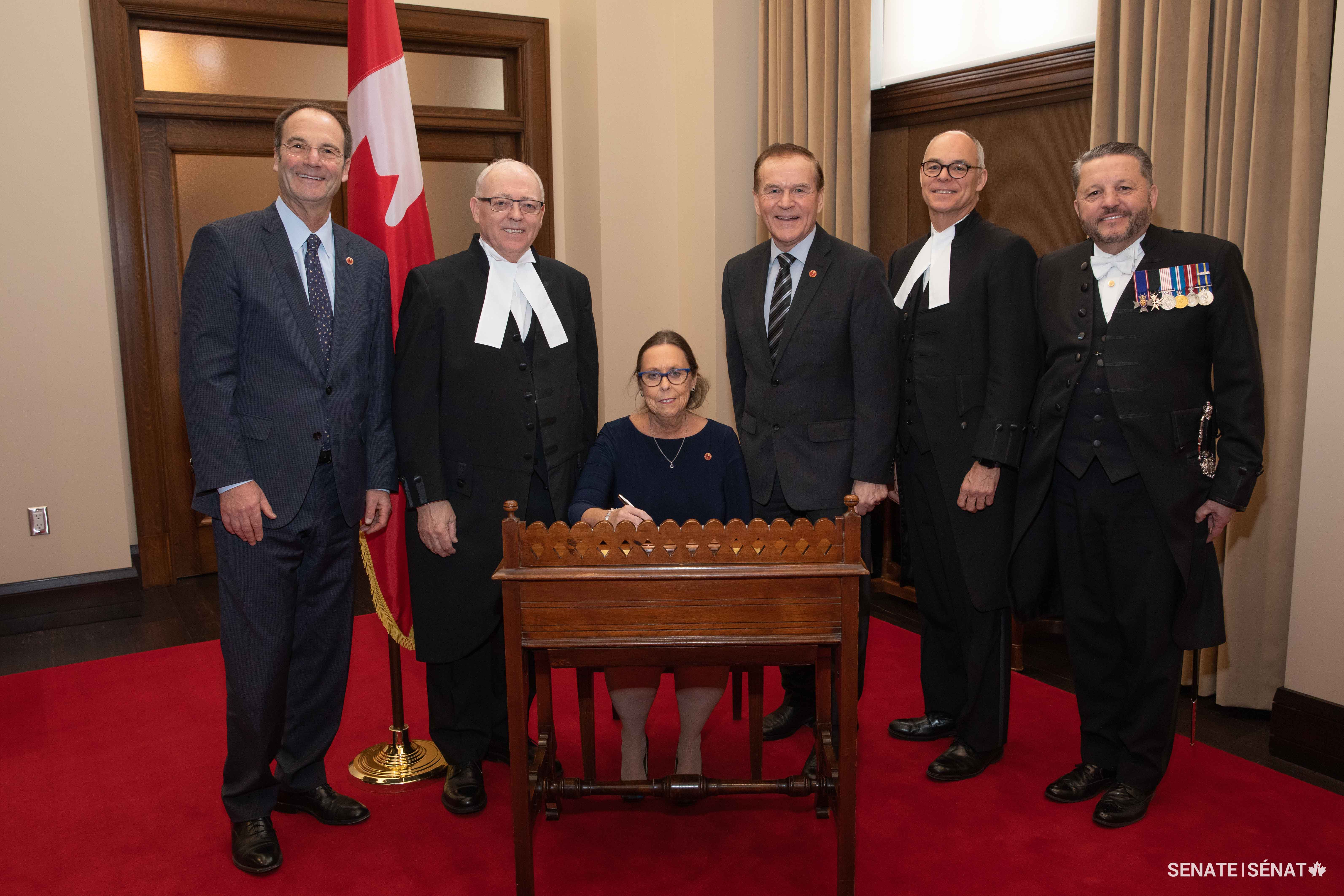 Standing from left to right, Senator Marc Gold, Speaker of the Senate George J. Furey, Senator Percy Mockler, former Clerk of the Senate Richard Denis and Usher of the Black Rod J. Greg Peters celebrate Senator Keating’s swearing-in on February 4, 2020.