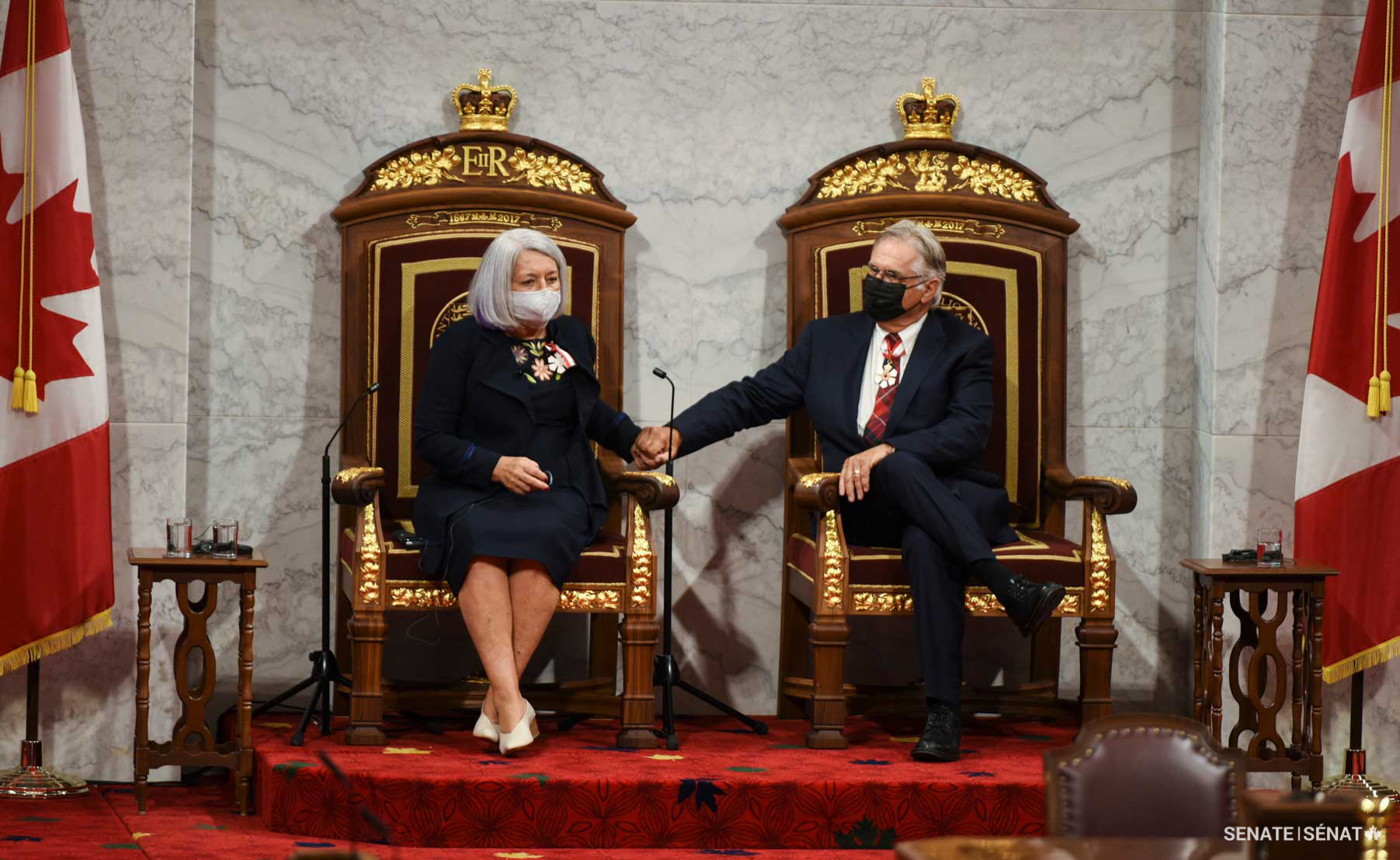 Governor General Mary Simon takes her place on the Throne of Canada, with her spouse Whit Fraser, seated on the consort’s throne.