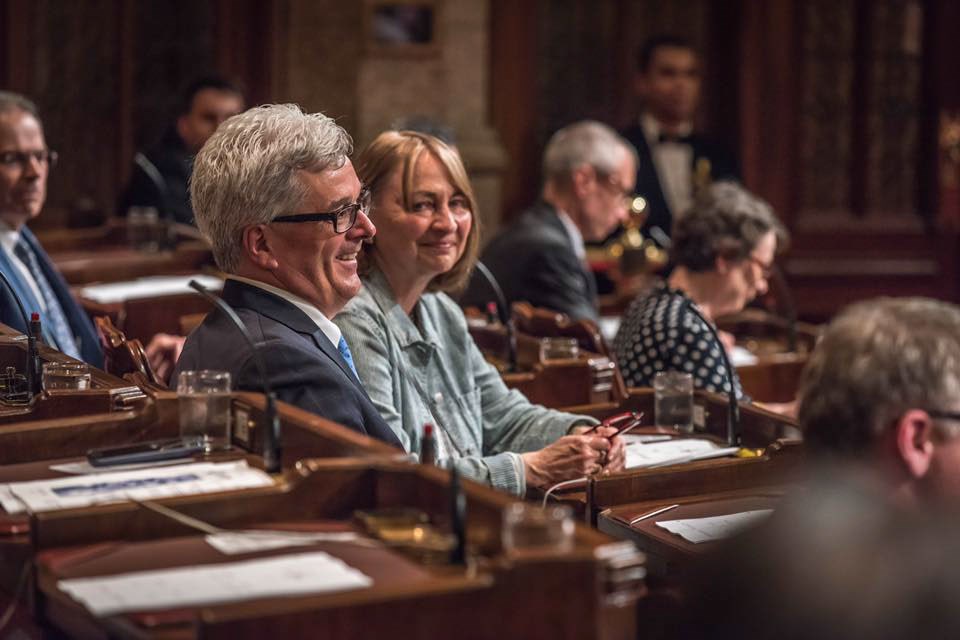 Senator Deacon with colleagues in the Senate Chamber following his swearing-in ceremony in June 2018.
