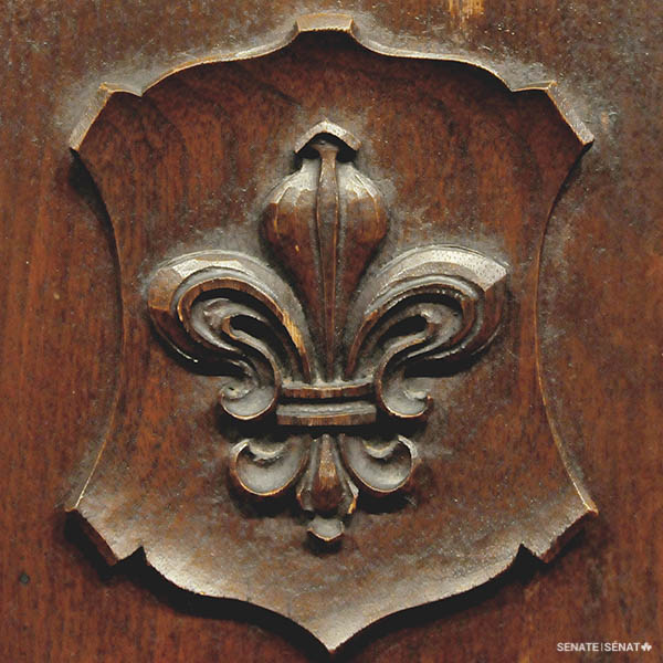 A fleur-de-lis adorns several desks.