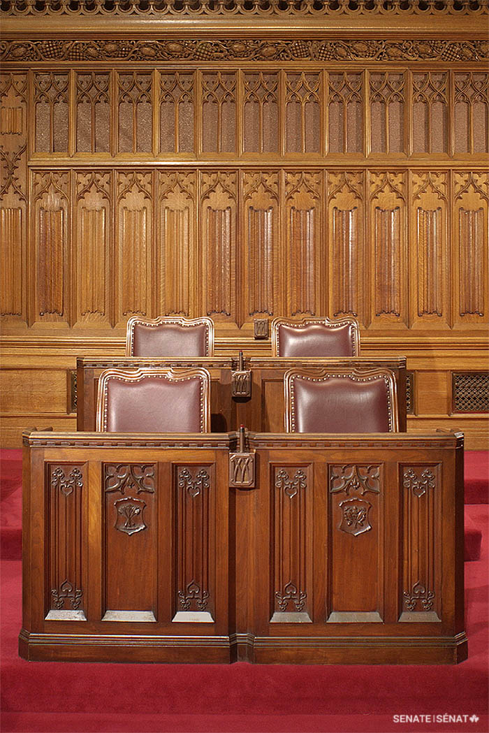 Senators’ desks pictured in Centre Block’s Senate Chamber shortly before the building was closed for rehabilitation. Front-row desks are decorated with botanical emblems.