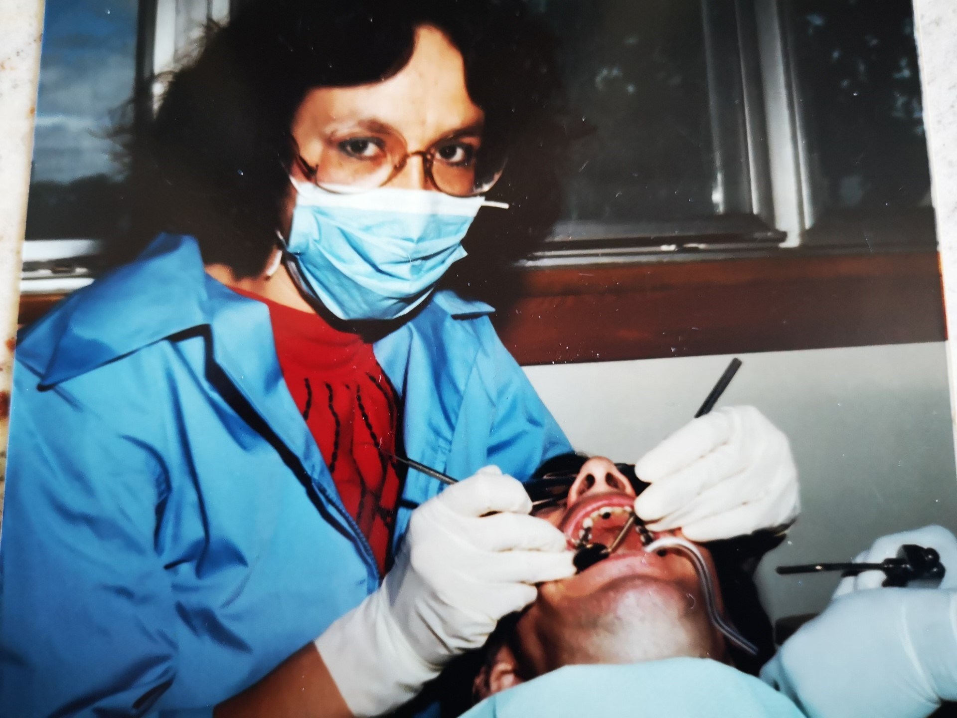 Senator McCallum looks up from a patient in this photo from 1978, when she was a dental nurse.