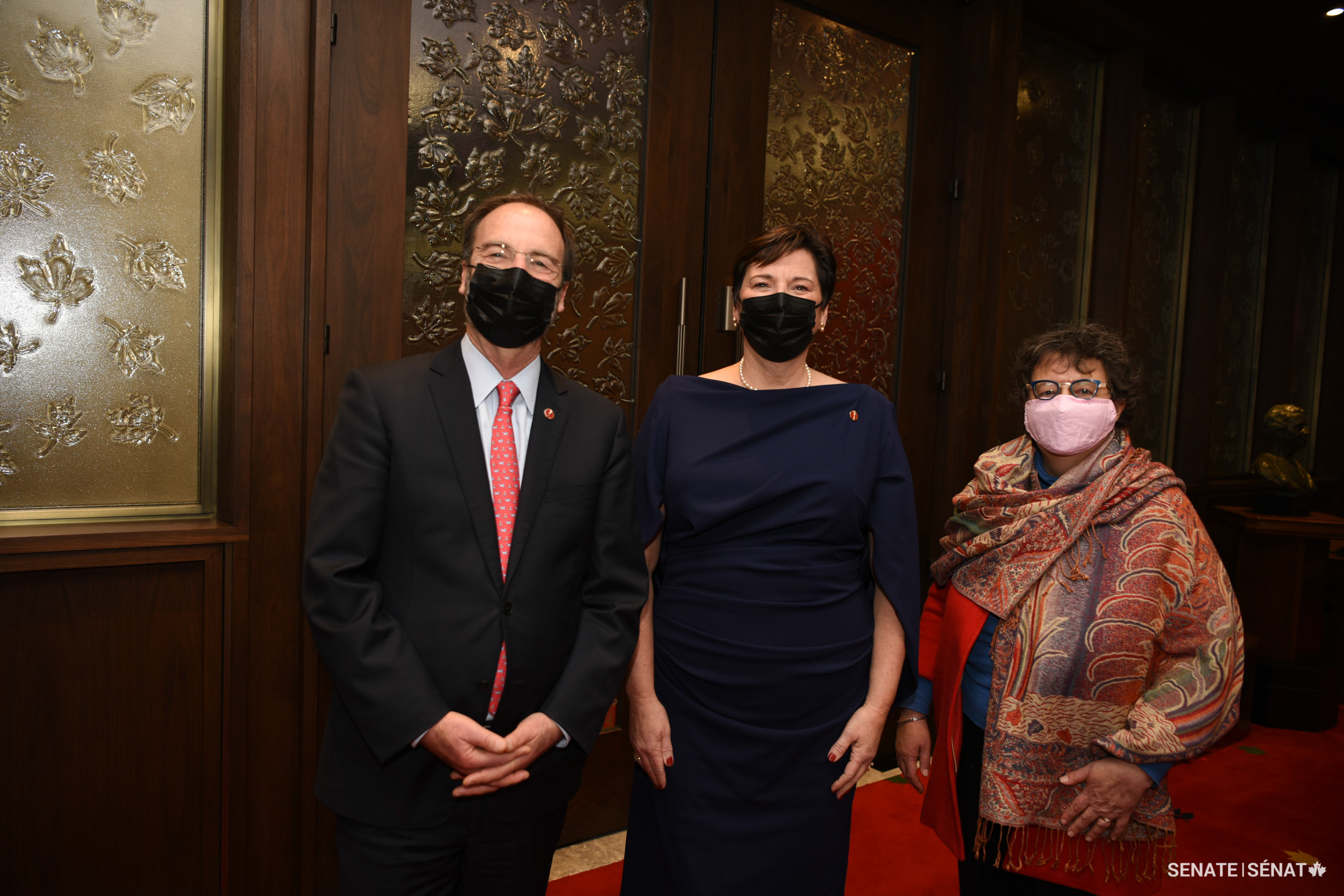 Senator Karen Sorensen, centre, stands with senators Marc Gold and Paula Simons after her swearing-in ceremony.