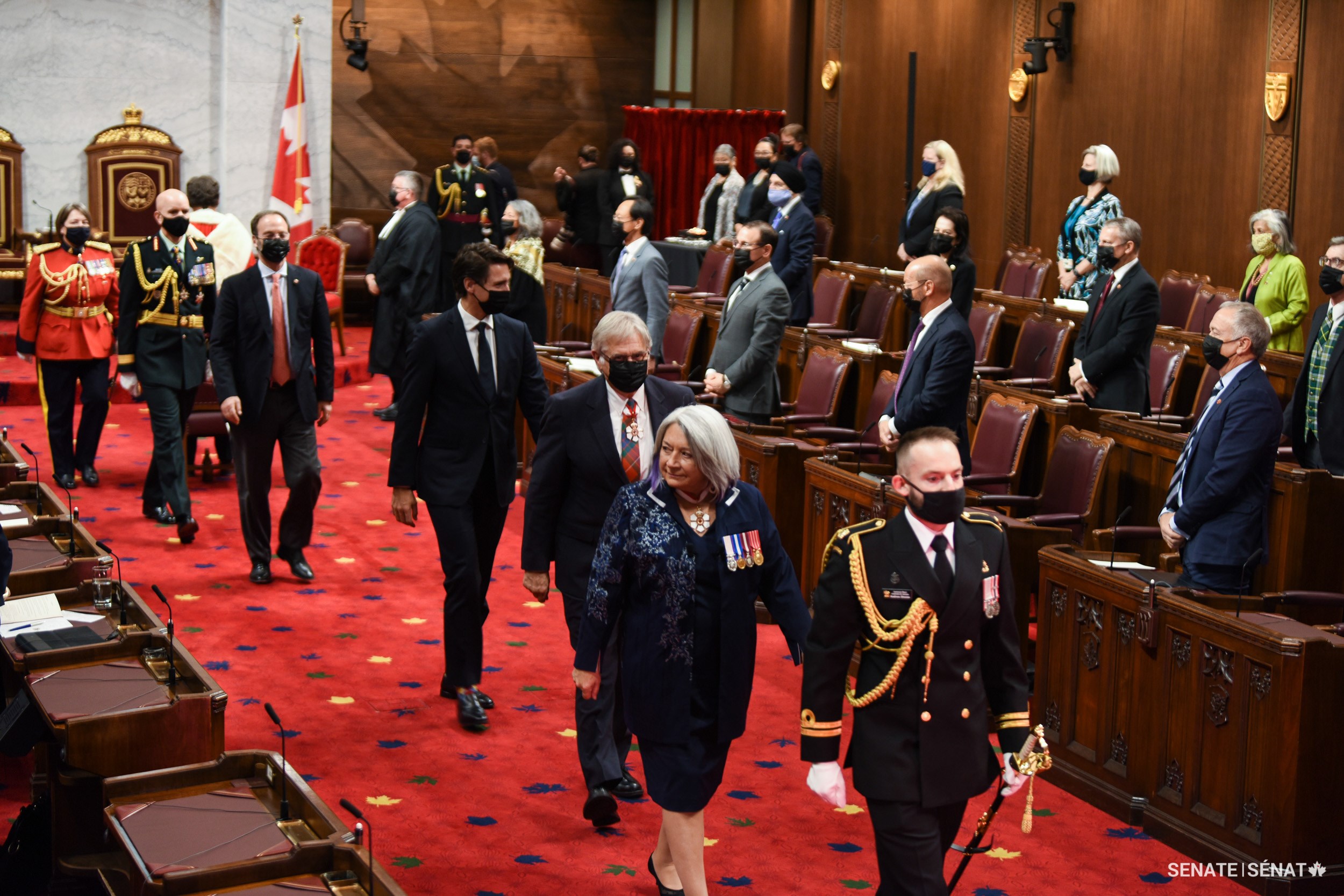 Senators rise in respect as the governor general leaves the Red Chamber.