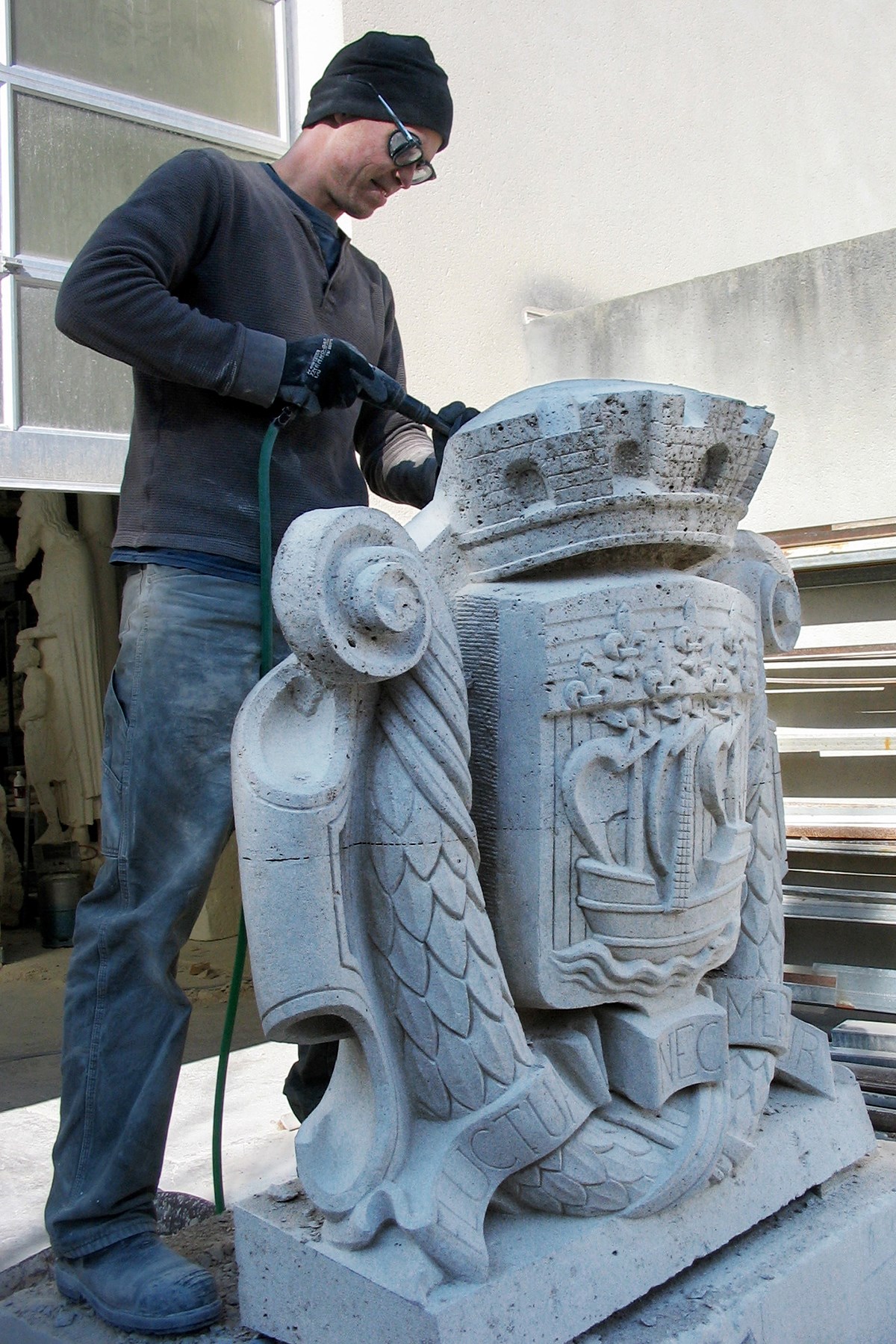 Mr. Smith works on a coat of arms for La Préfecture de Paris in 2011. (Photo credit: John-Philippe Smith)