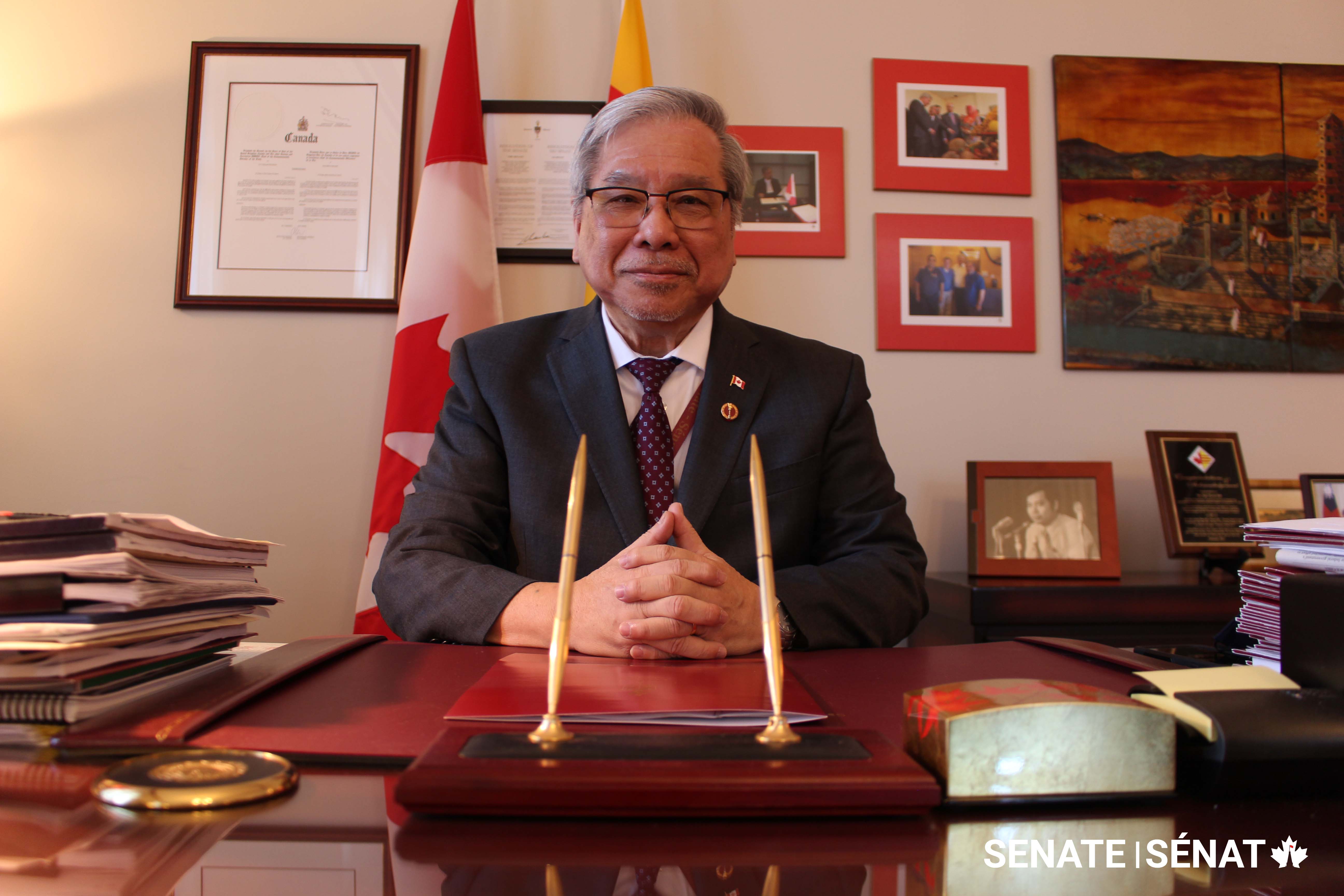 Senator Ngo at his desk in East Block. The yellow flag of South Vietnam is just visible behind his head; he was never able to return to his country of birth after the South fell in 1975.