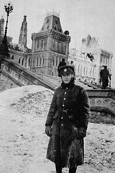 A firefighter pictured outside the ruin the morning after the fire. (Photo credit: Library and Archives Canada)