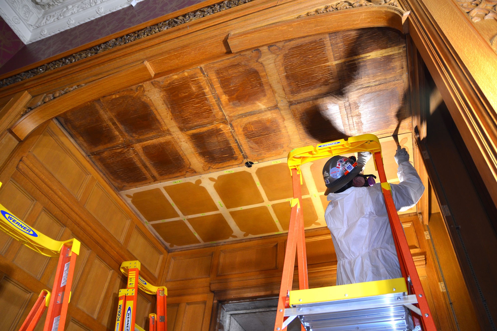 In an alcove in the Senate Reading Room, conservators are surprised and delighted to find the original ceiling underneath the dismantled contemporary one.