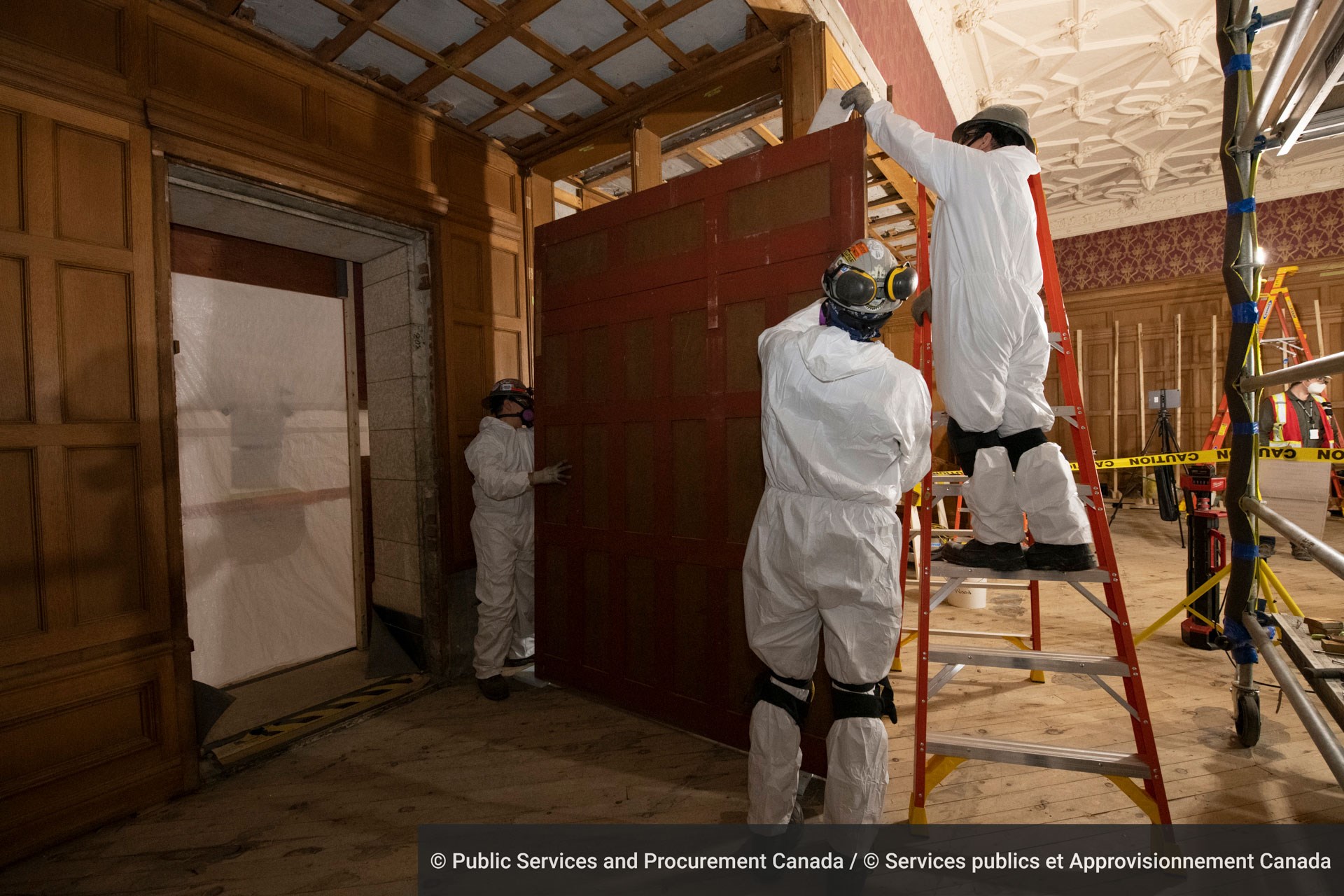 Workers remove a wooden wall panel in the Senate Reading Room, a space where senators would traditionally go to read newspapers and have a bite between sittings and committee meetings.