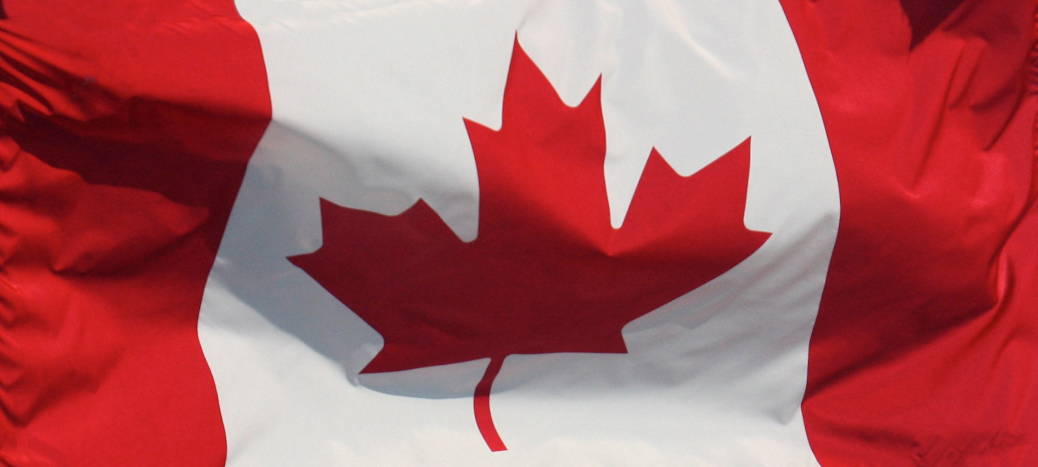 The Canadian flag billowing in the wind