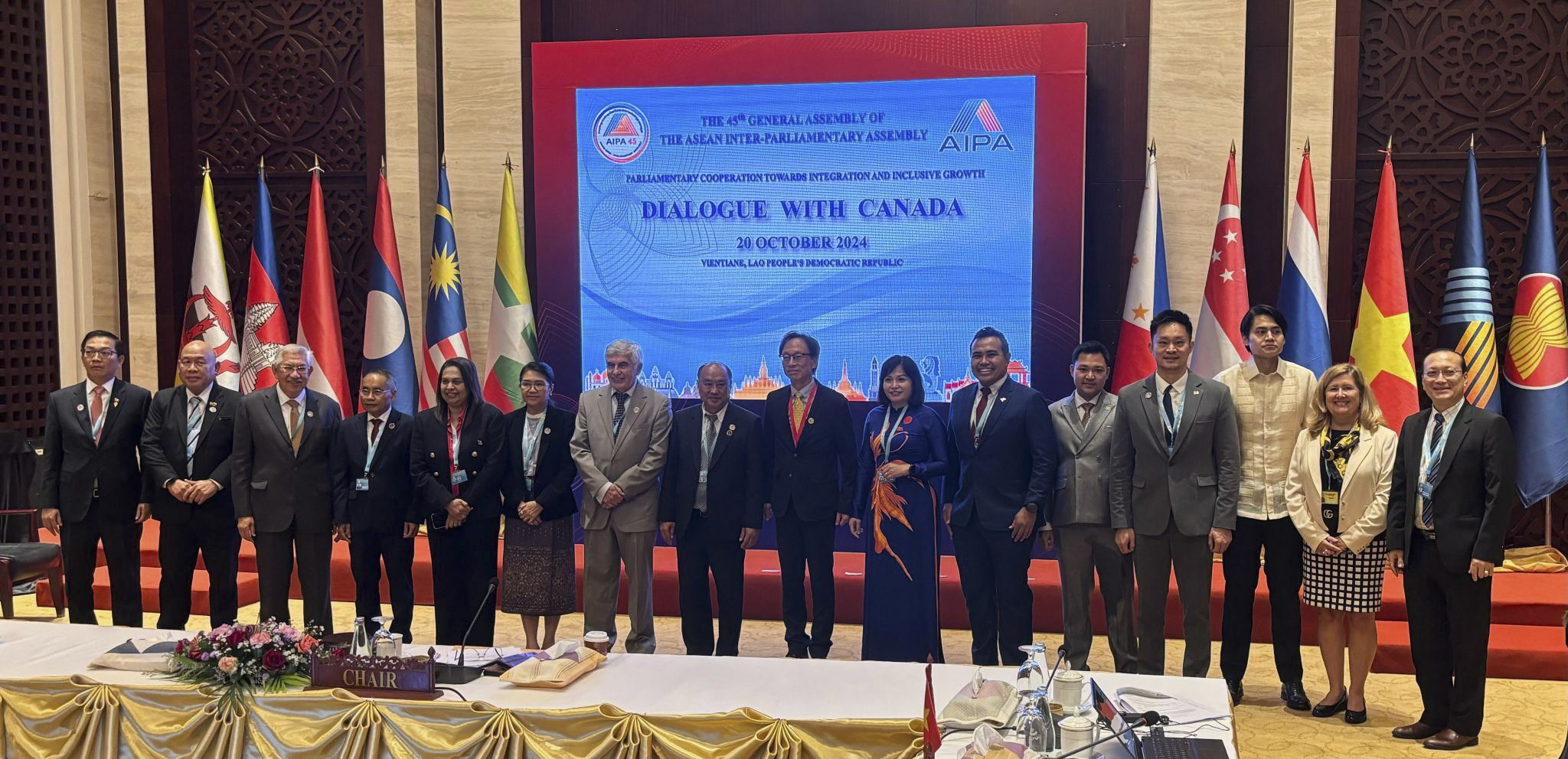 Sunday, October 20, 2024 – Senators Clément Gignac, seventh from left, Yuen Pau Woo, centre, and Krista Ross, second from right, and other representatives from international delegations; Dialogue With Canada event during the 45th General Assembly of the ASEAN Inter-Parliamentary Assembly; Vientiane, Laos.