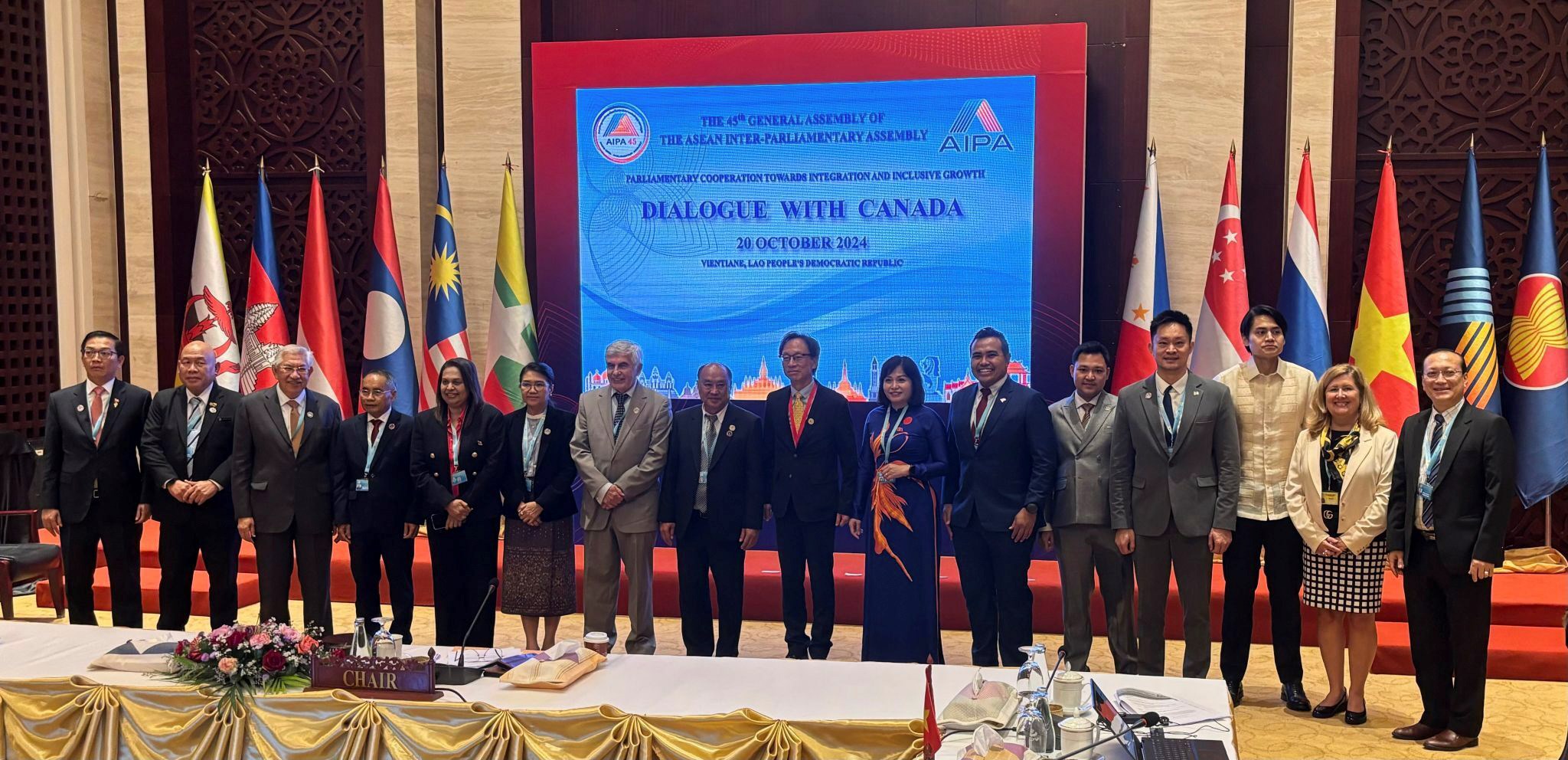 Sunday, October 20, 2024 – Senators Clément Gignac, seventh from left, Yuen Pau Woo, centre, and Krista Ross, second from right, and other representatives from international delegations; Dialogue With Canada event during the 45th General Assembly of the ASEAN Inter-Parliamentary Assembly; Vientiane, Laos.