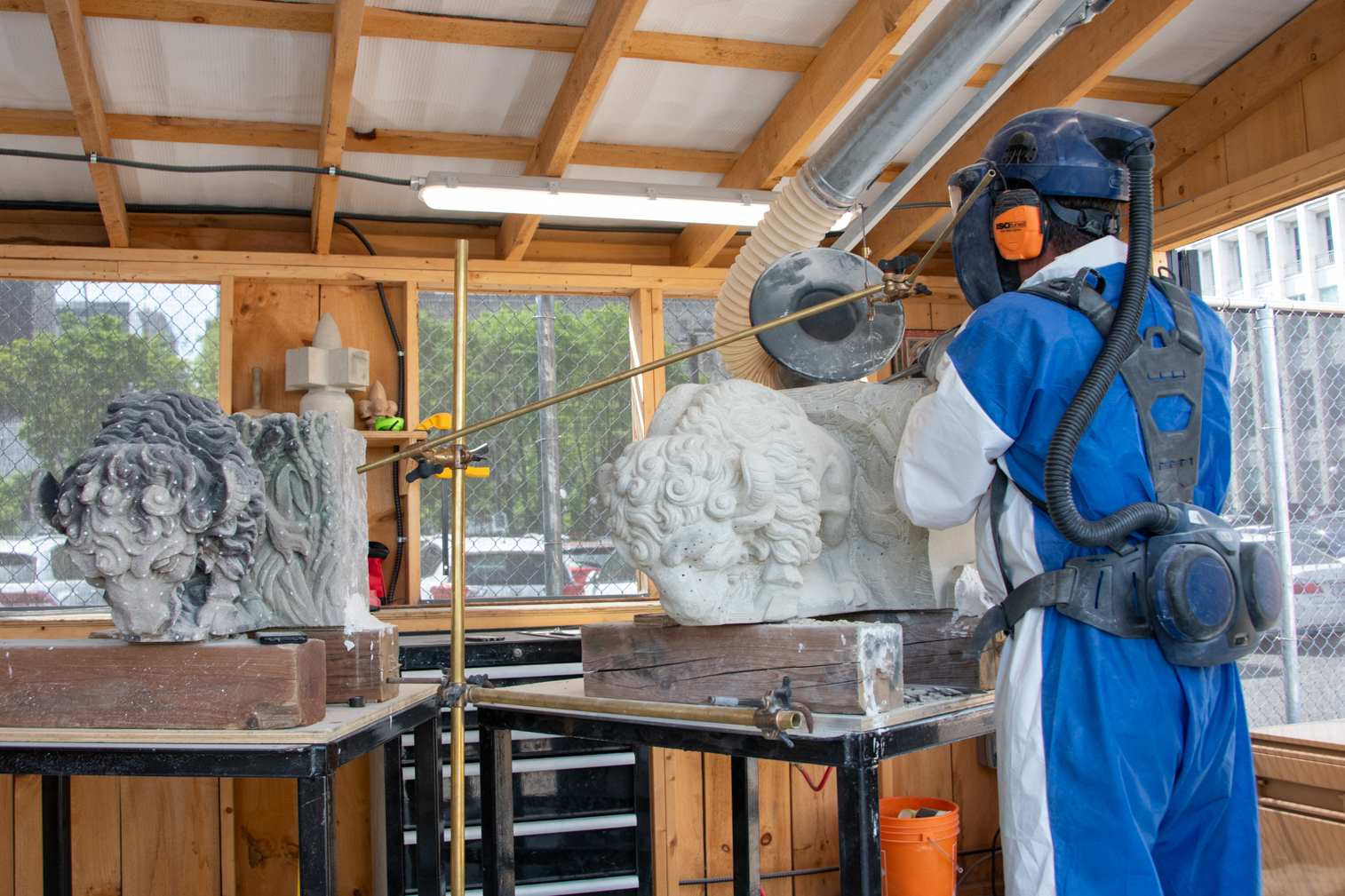 Mr. Barber uses a pointing machine to transfer measurements from the original carving to its duplicate. The device, invented in the 1700s, uses a stylus to pinpoint features on the original and a flexible arm to transfer their exact co-ordinates to the duplicate.